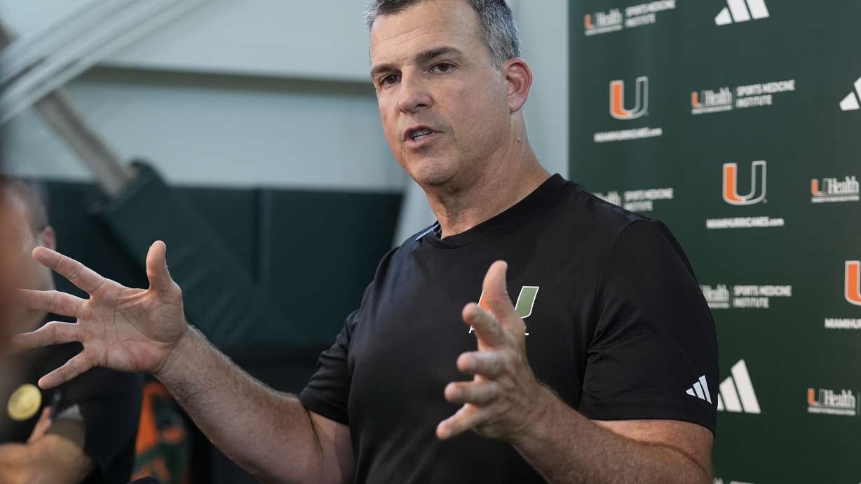 Miami head coach Mario Cristobal speaks with the media following NCAA college football practice, Wednesday, July 31, 2024, in Coral Gables, Fla.