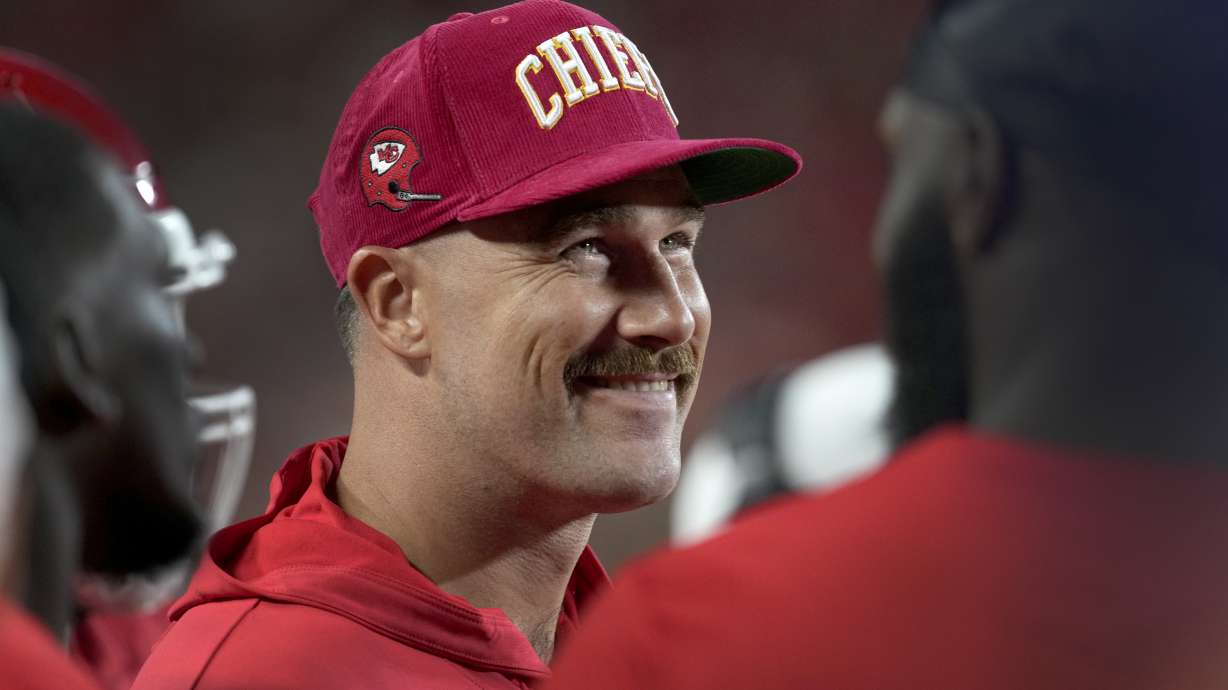 Kansas City Chiefs tight end Travis Kelce smiles on the sidelines during the first half of an NFL preseason football game against the Chicago Bears Thursday, Aug. 22, 2024, in Kansas City, Mo.