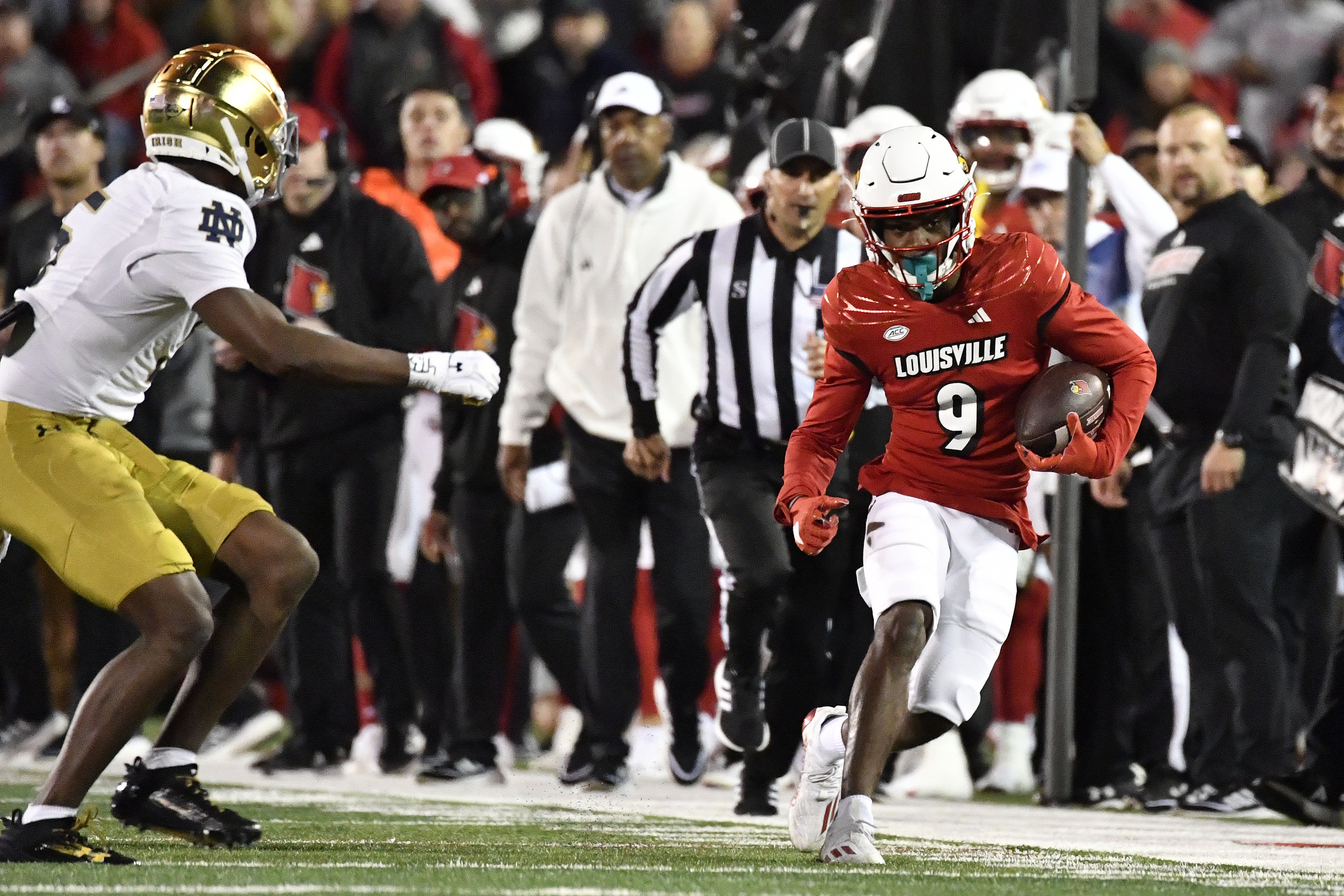 FILE - Louisville wide receiver Ahmari Huggins-Bruce (9) is chased by Notre Dame cornerback Cam Hart after a long gain during the second half of an NCAA college football game in Louisville, Ky., Oct. 7, 2023. 