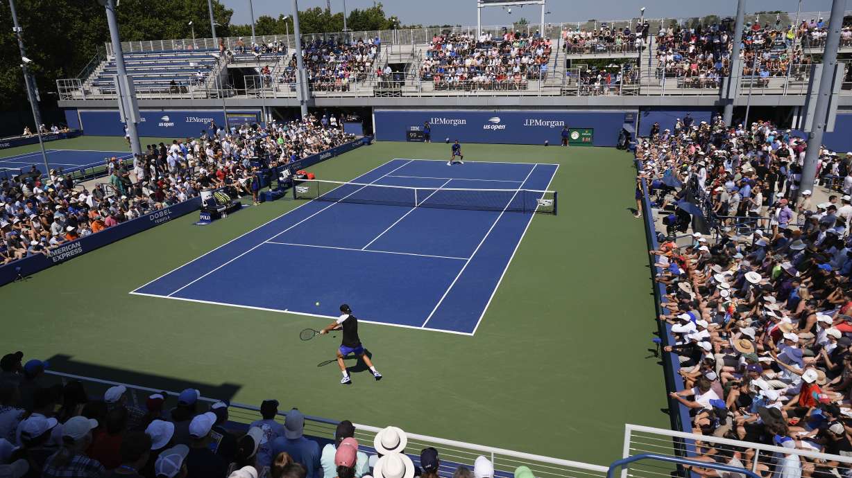 Jakub Mensik, of the Czech Republic, returns a shot to Felix Auger-Aliassime, of Canada, during the first round of the U.S. Open tennis championships, Tuesday, Aug. 27, 2024, in New York.