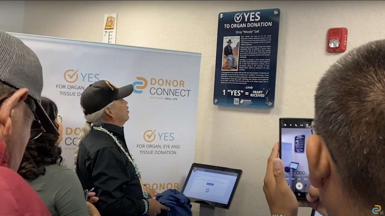 Elroy "Woody" Salt looks at a plaque in his honor installed at the Blanding Driver License Division on Aug. 21.