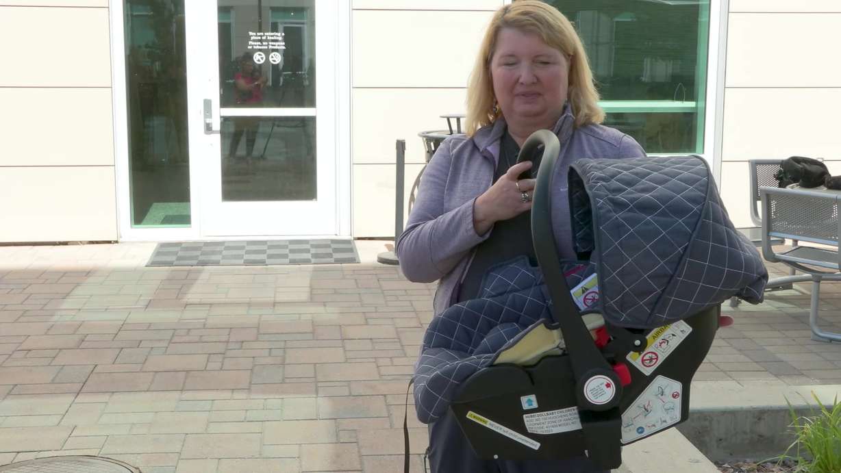 Car seat technician Ruth Vayo shows off what was wrong with Jillian Davis’s car seat.