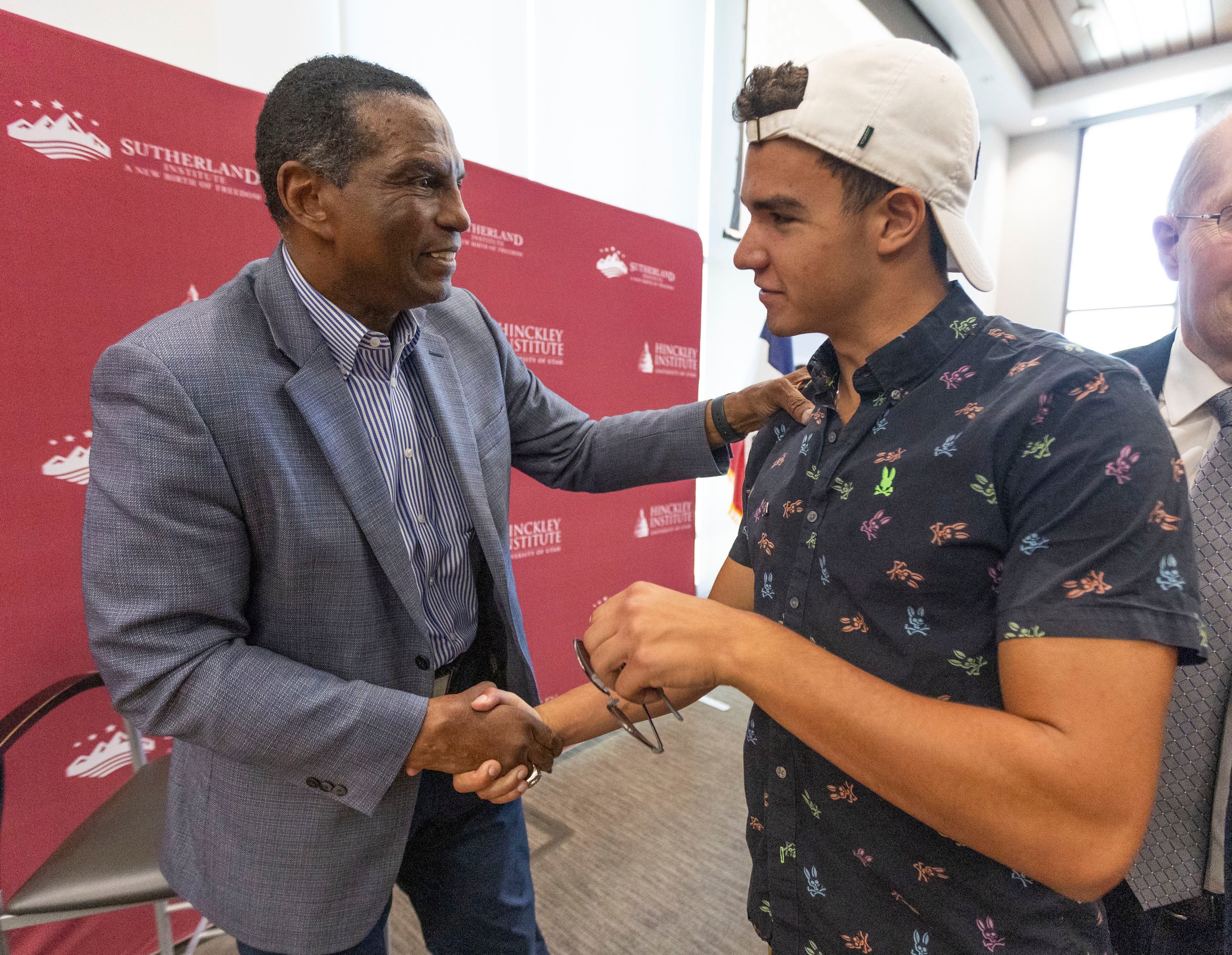 Rep. Burgess Owens, R-Utah, shakes hands with Jackson Talley, a political science major at the University of Utah, at the University of Utah campus in Salt Lake City on Tuesday.
