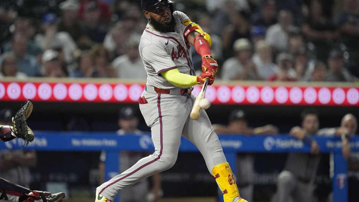 Atlanta Braves designated hitter Marcell Ozuna hits a double during the 10th inning of a baseball game against the Minnesota Twins, Tuesday, Aug. 27, 2024, in Minneapolis.