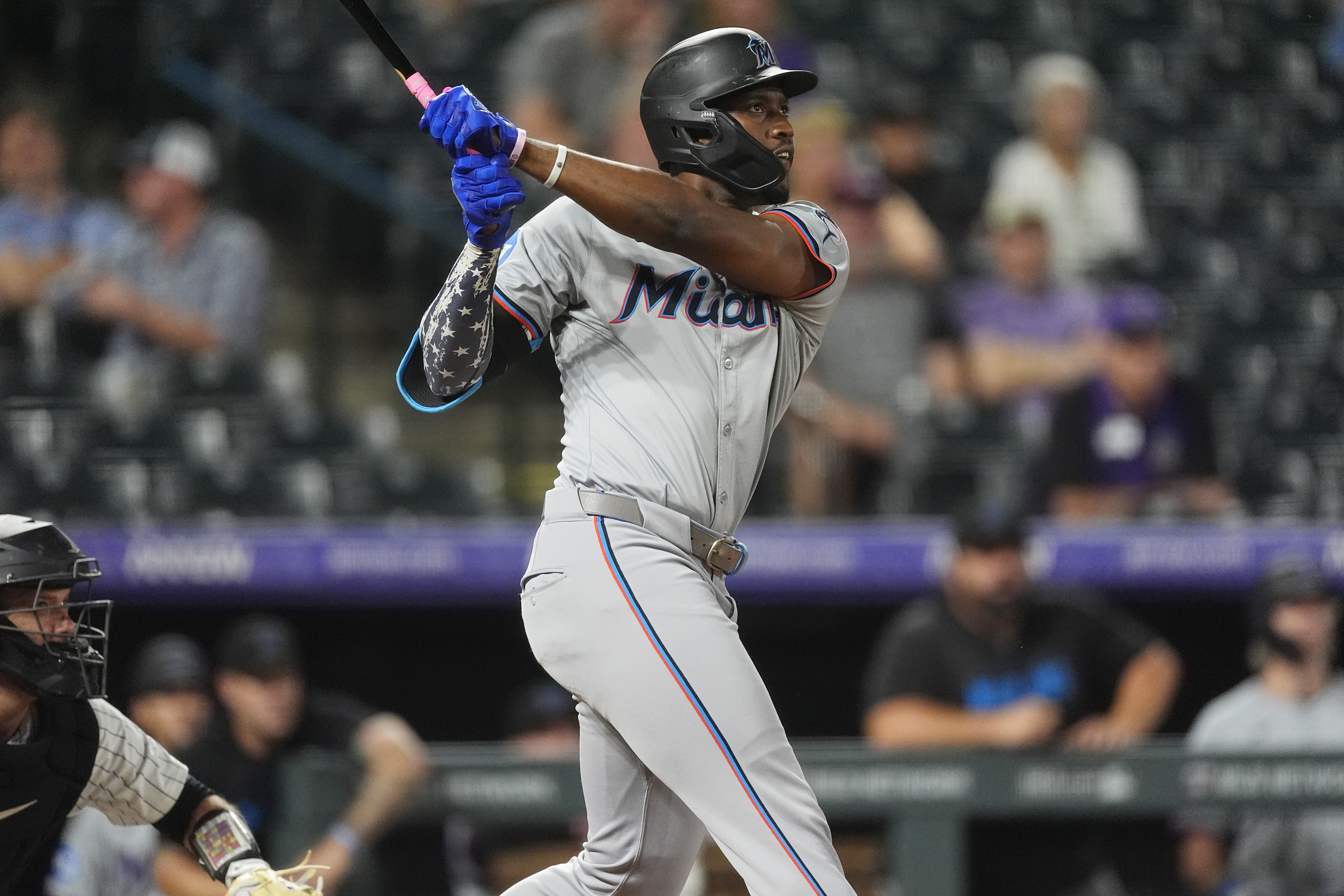 Miami Marlins' Jesus Sanchez follows the flight of his three-run home run off Colorado Rockies relief pitcher Angel Chivilli in the ninth inning of after a baseball game, Tuesday, Aug. 27, 2024, in Denver. 
