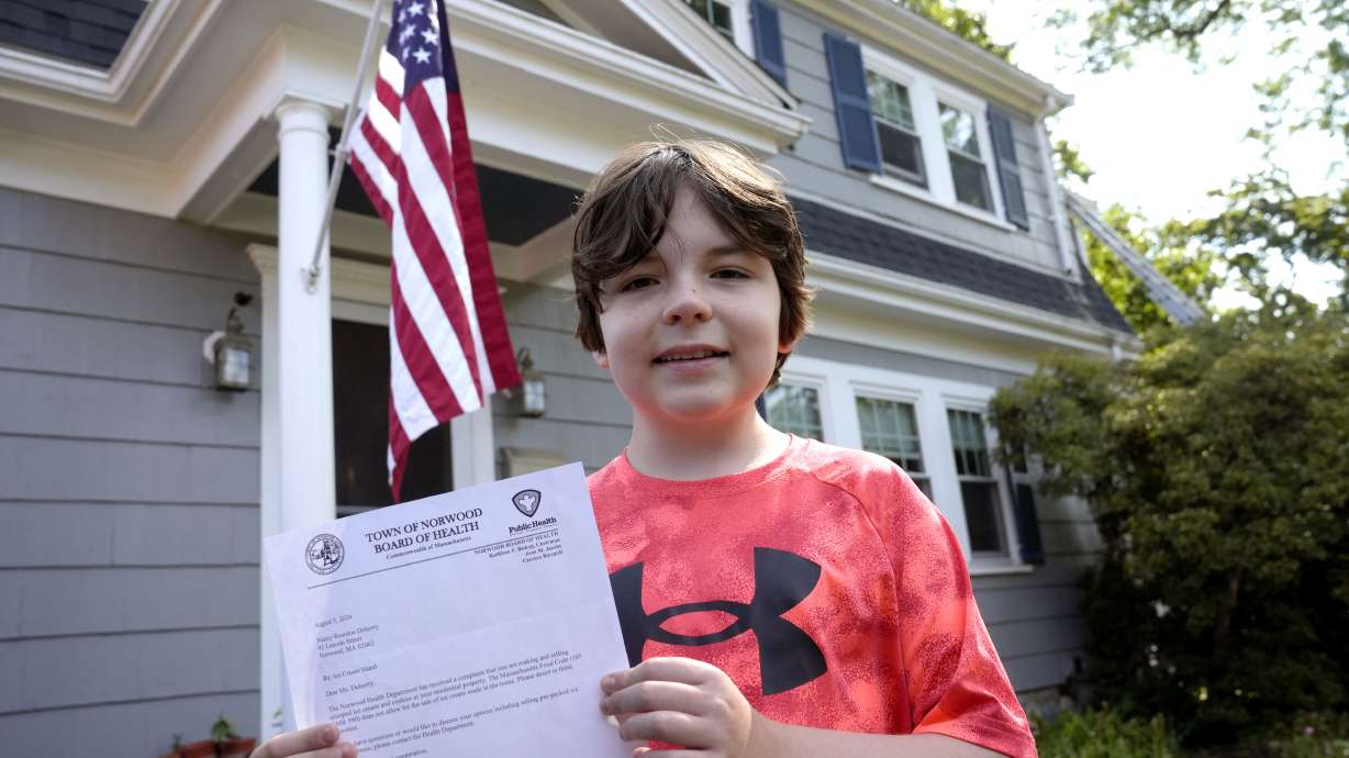 Danny Doherty, 12, of Norwood, Mass., Aug. 21, in front of his home holding a letter from the Town of Norwood Board of Health advising his family that they may not sell homemade ice cream at an ice cream stand near their home.