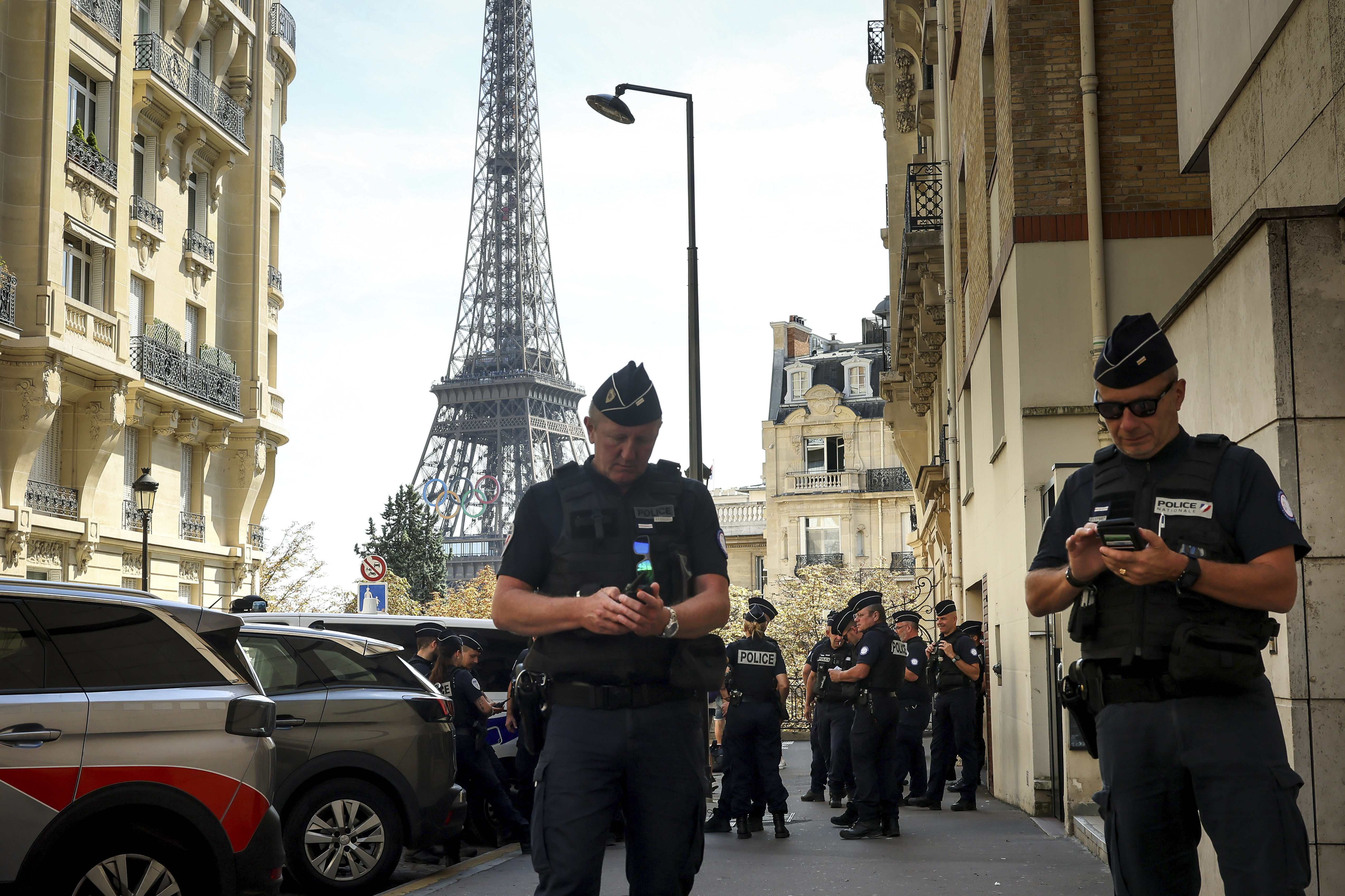 Police officers gather in a street near the Eiffel Tower on the eve of the Paralympic Games opening ceremony, Tuesday, Aug. 27, 2024 in Paris. 