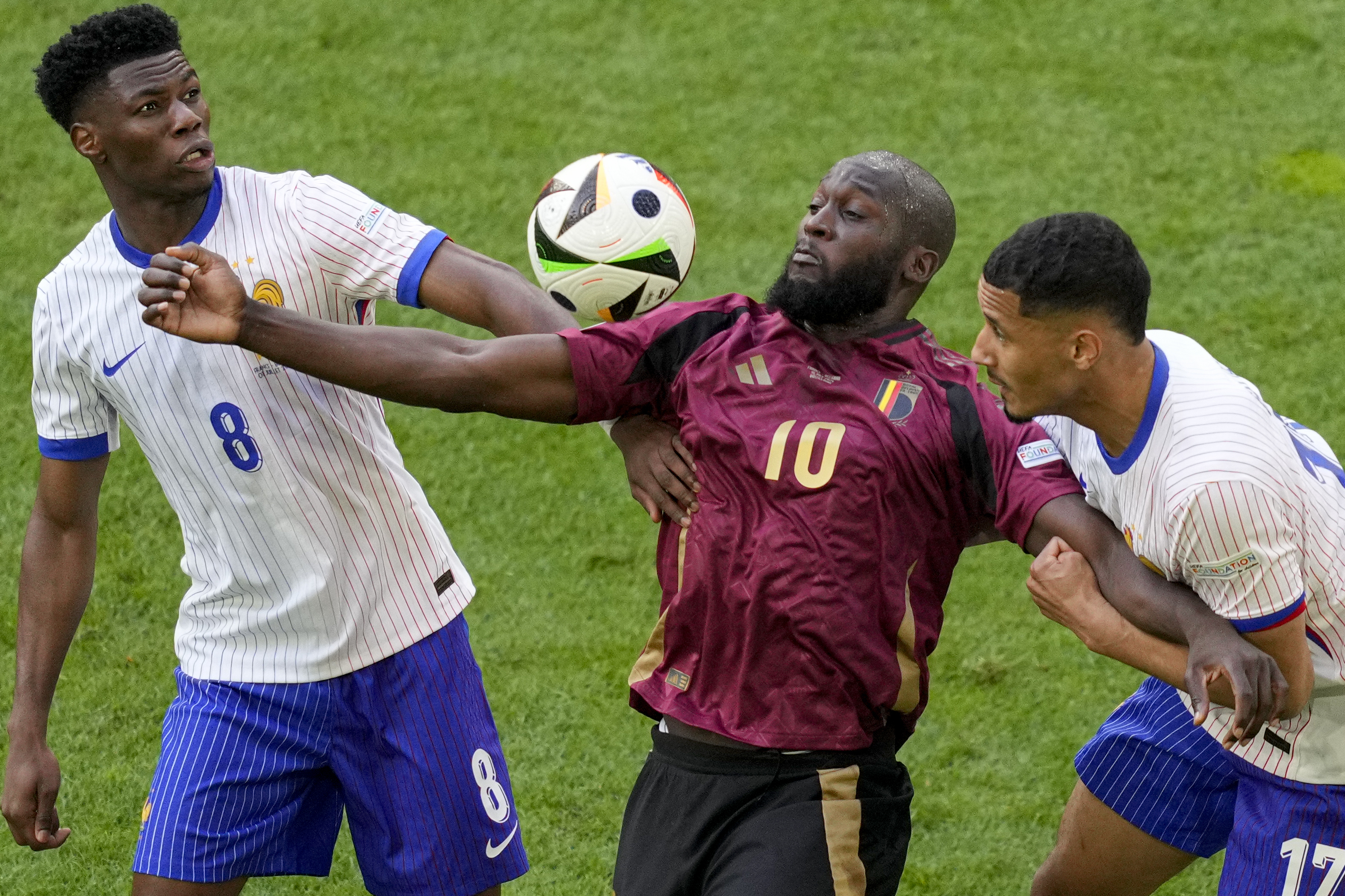 FILE - Belgium's Romelu Lukaku is challenged by Aurelien Tchouameni of France and William Saliba of France during a round of sixteen match between France and Belgium at the Euro 2024 soccer tournament in Duesseldorf, Germany, Monday, July 1, 2024. 