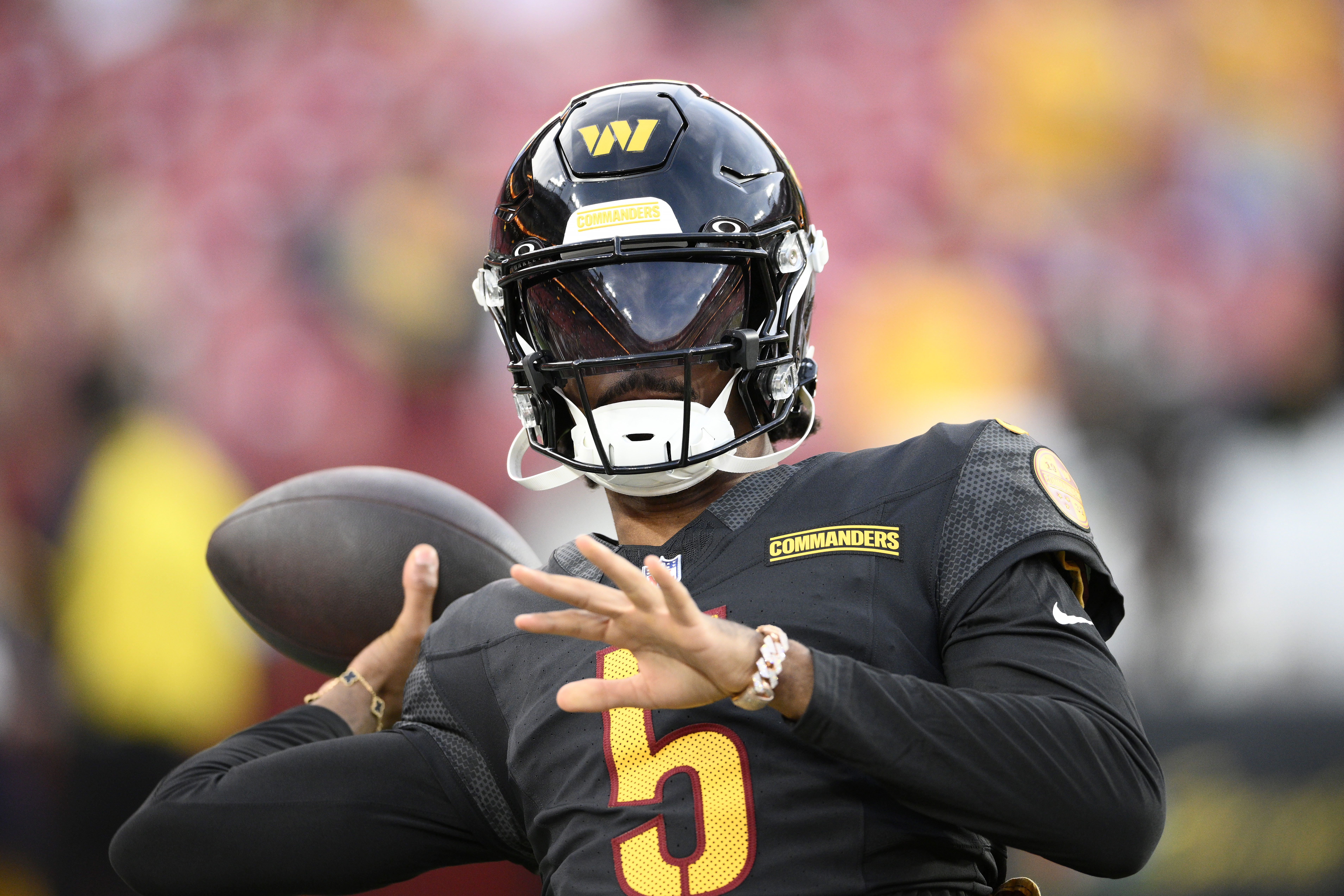 Washington Commanders quarterback Jayden Daniels warms up before a preseason NFL football game against the New England Patriots, Sunday, Aug. 25, 2024, in Landover, Md. 