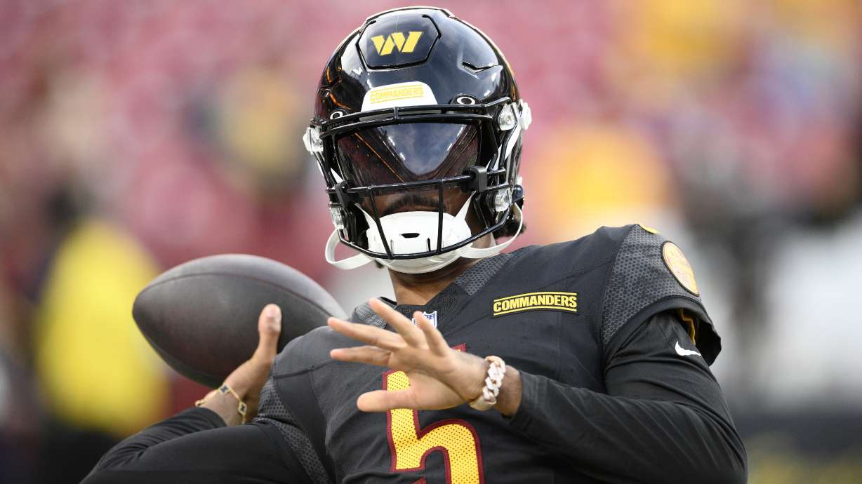 Washington Commanders quarterback Jayden Daniels warms up before a preseason NFL football game against the New England Patriots, Sunday, Aug. 25, 2024, in Landover, Md.