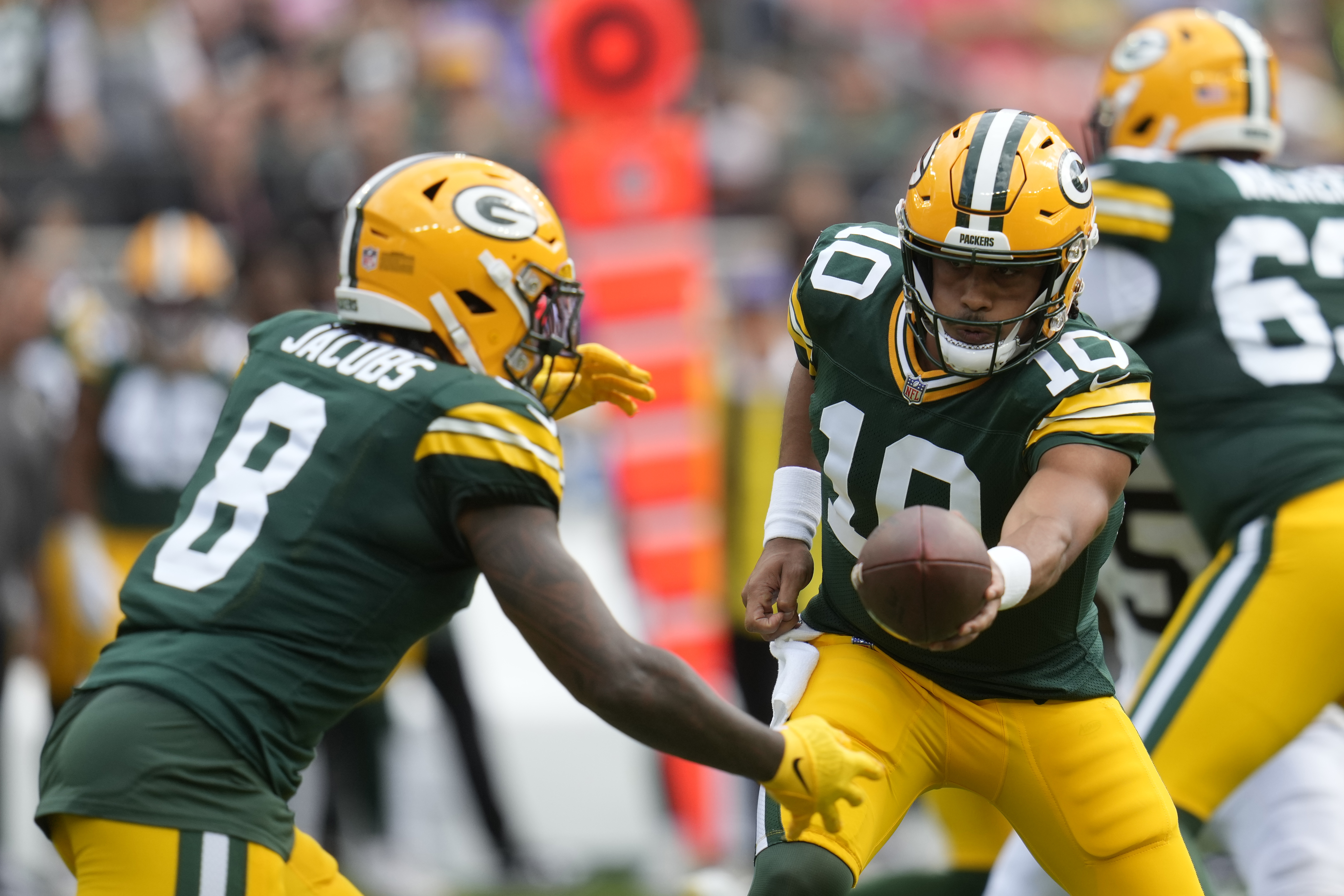 Green Bay Packers quarterback Jordan Love (10) hands off to running back Josh Jacobs (8) during the first half of an NFL preseason football game against the Cleveland Browns, Saturday, Aug. 10, 2024, in Cleveland. 