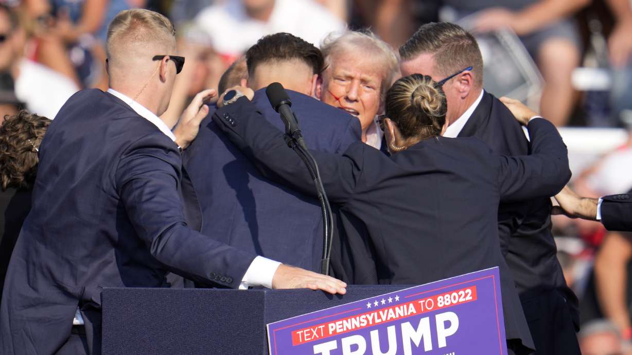 Republican presidential candidate former President Donald Trump is surrounded by Secret Service at a campaign event in Butler, Pa., July 13. A senior FBI official says the gunman in the assassination attempt on Trump saw the rally where he opened fire as a "target of opportunity."