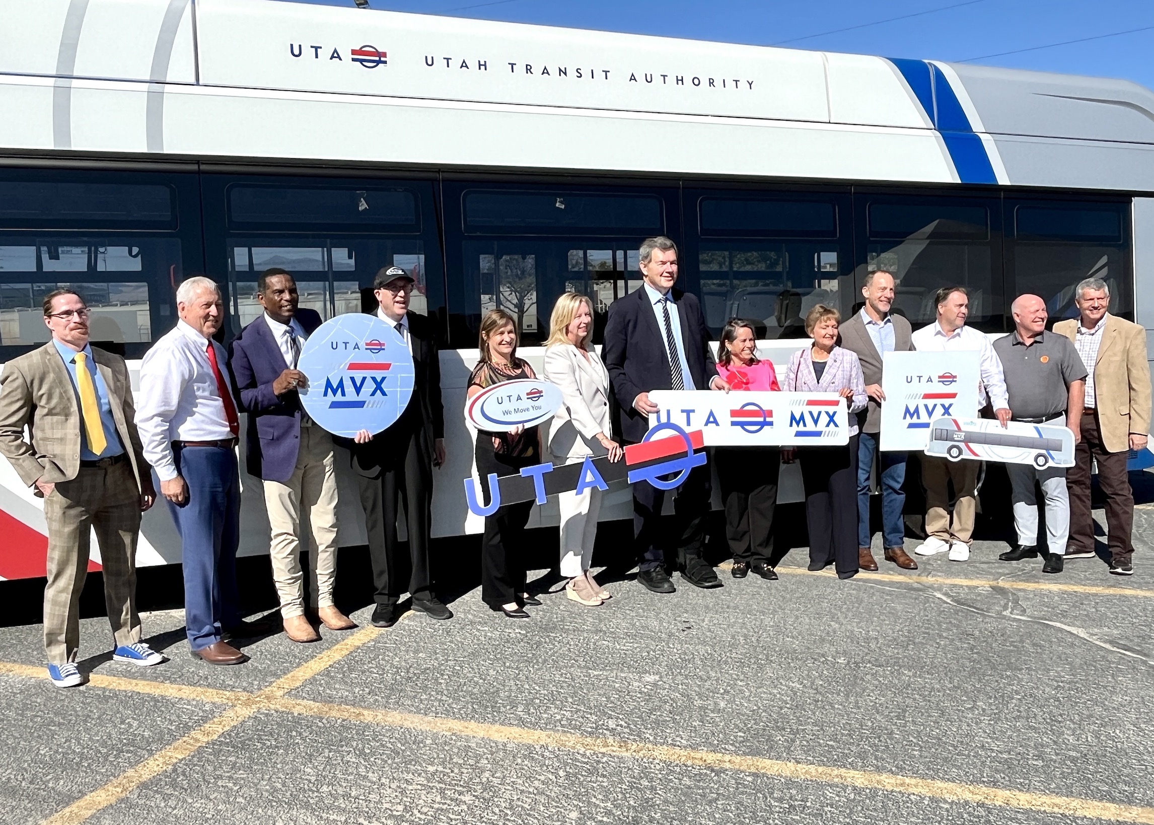 Local, state and federal representatives pose in from of a Utah Transit Authority bus near Murray Central Station on Wednesday. Construction on the Midvalley Express is underway and expected to end in 2026.
