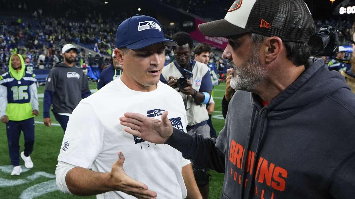 Seattle Seahawks head coach Mike Macdonald, left, shakes hands with Cleveland Browns head coach Kevin Stefanski after a preseason NFL football game Saturday, Aug. 24, 2024, in Seattle. The Seahawks won 37-33.