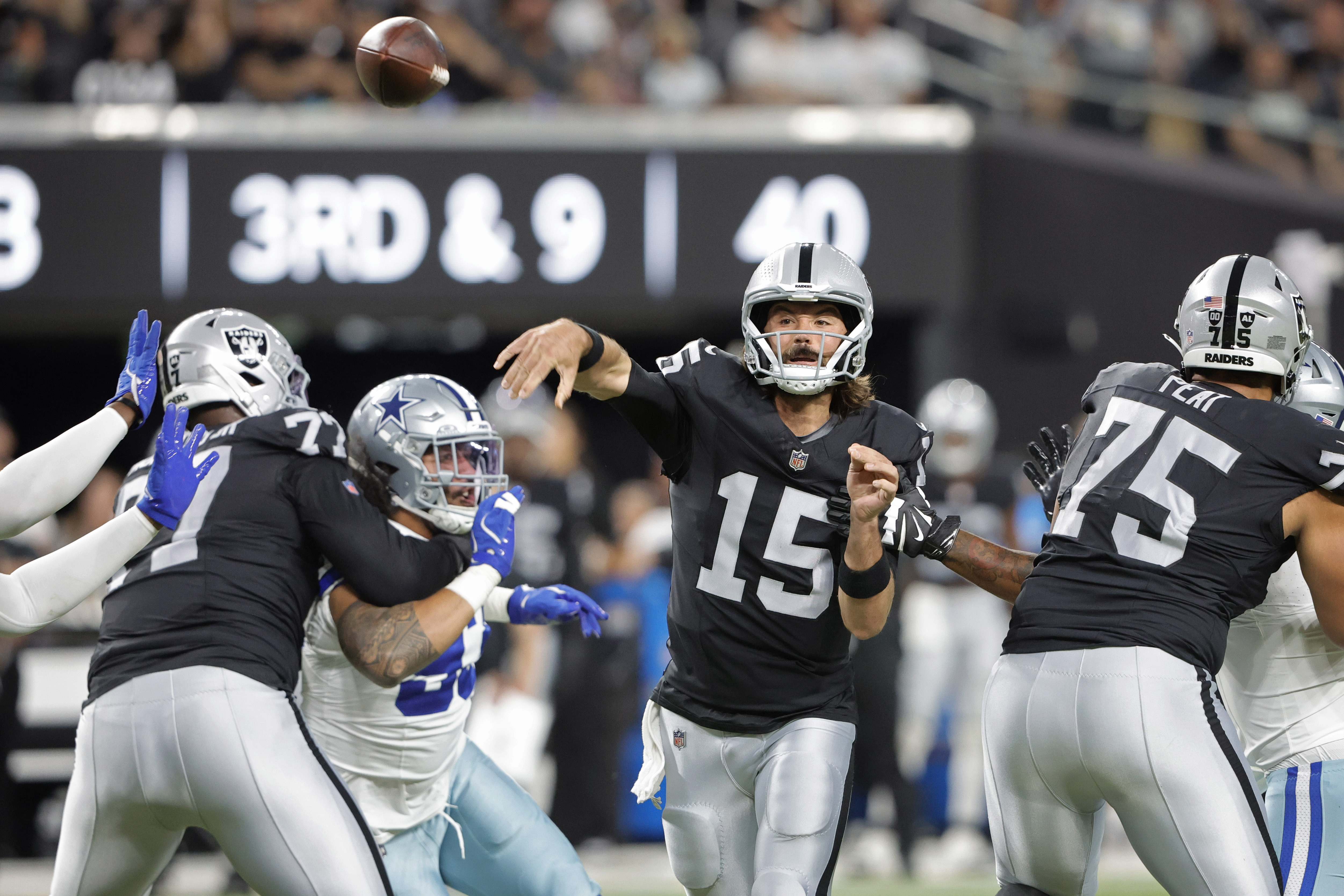 Las Vegas Raiders quarterback Gardner Minshew (15) throws against the Dallas Cowboys during the first half of an NFL preseason football game, Saturday, Aug. 17, 2024, in Las Vegas. 