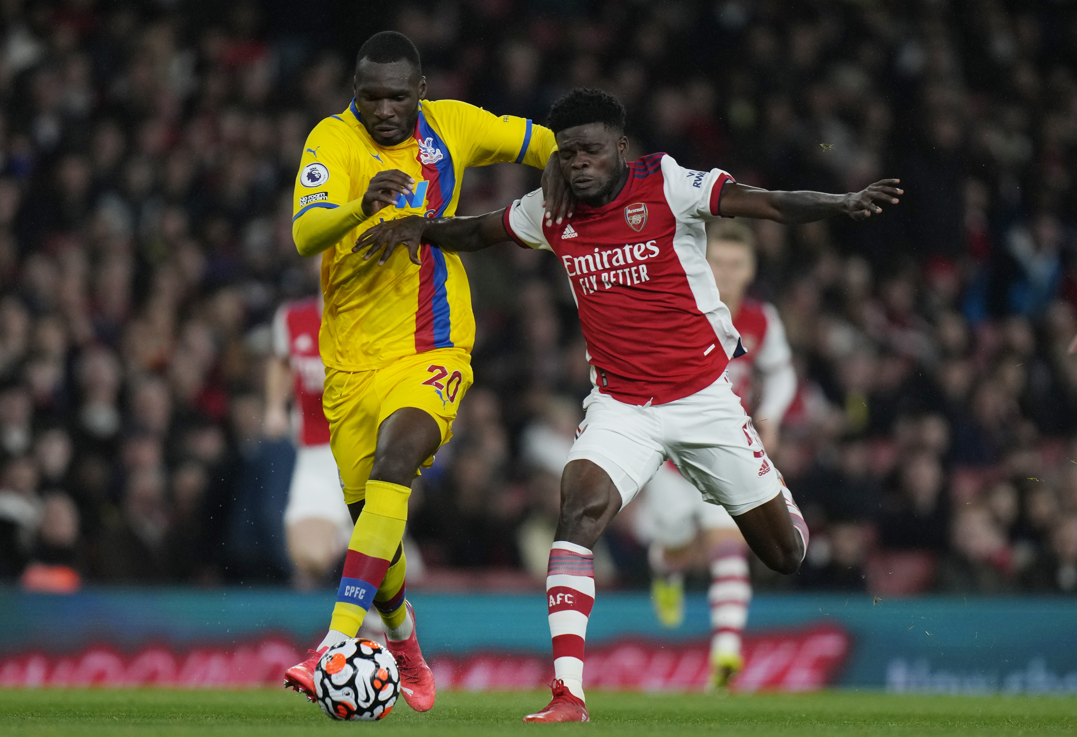 FILE - Crystal Palace's Christian Benteke, left, challenges for the ball with Arsenal's Thomas Partey during an English Premier League soccer match between Arsenal and Crystal Palace at the Emirates Stadium in London, England, Oct. 18, 2021. 