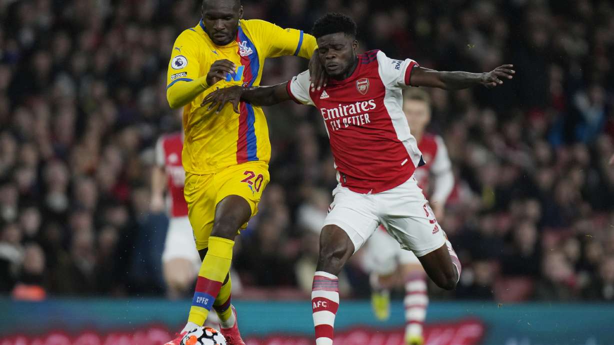 FILE - Crystal Palace's Christian Benteke, left, challenges for the ball with Arsenal's Thomas Partey during an English Premier League soccer match between Arsenal and Crystal Palace at the Emirates Stadium in London, England, Oct. 18, 2021.