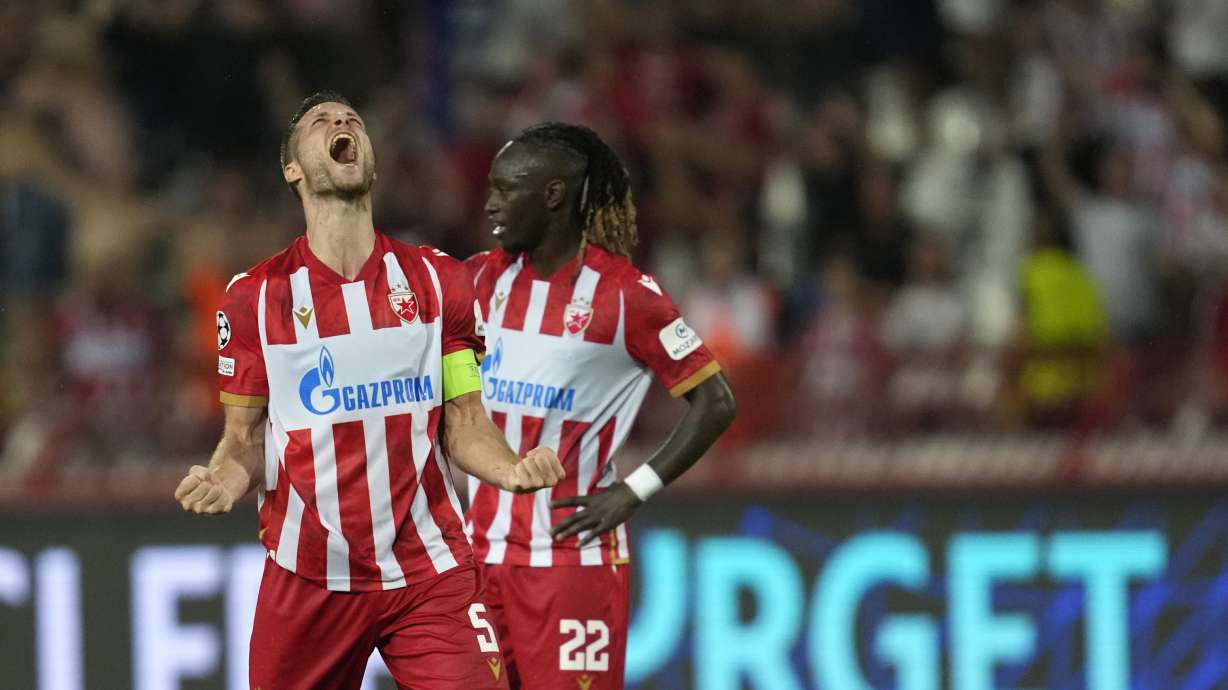 Red Star's Uros Spajic, left, and Red Star's Dalcio Gomes celebrate their victory at the Champions League play-off second leg soccer match between Red Star and Bodo Glimt, at the Rajko Mitic Stadium, in Belgrade, Serbia, Wednesday, Aug. 28, 2024.