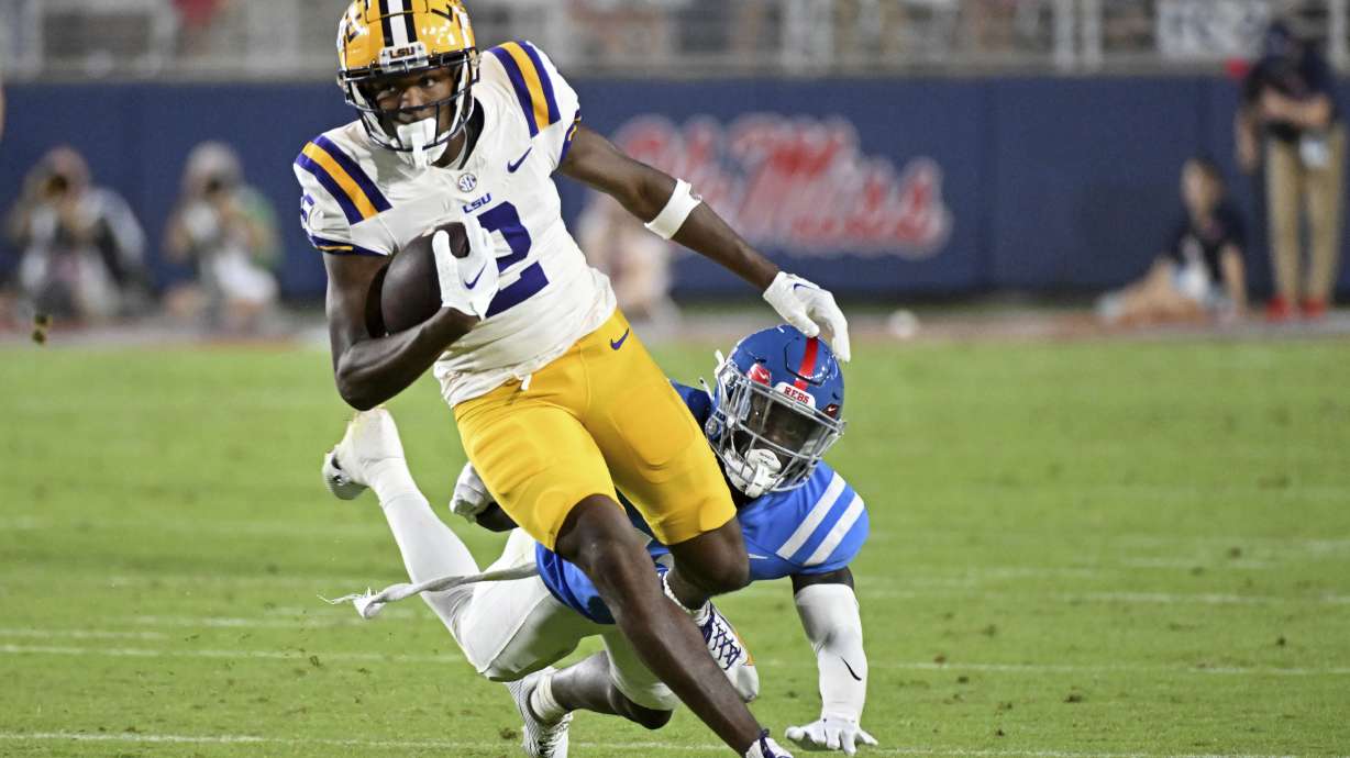 FILE - LSU wide receiver Kyren Lacy (2) avoids Mississippi safety Ladarius Tennison (13) during the second half of an NCAA college football game in Oxford, Miss., Sept. 30, 2023.