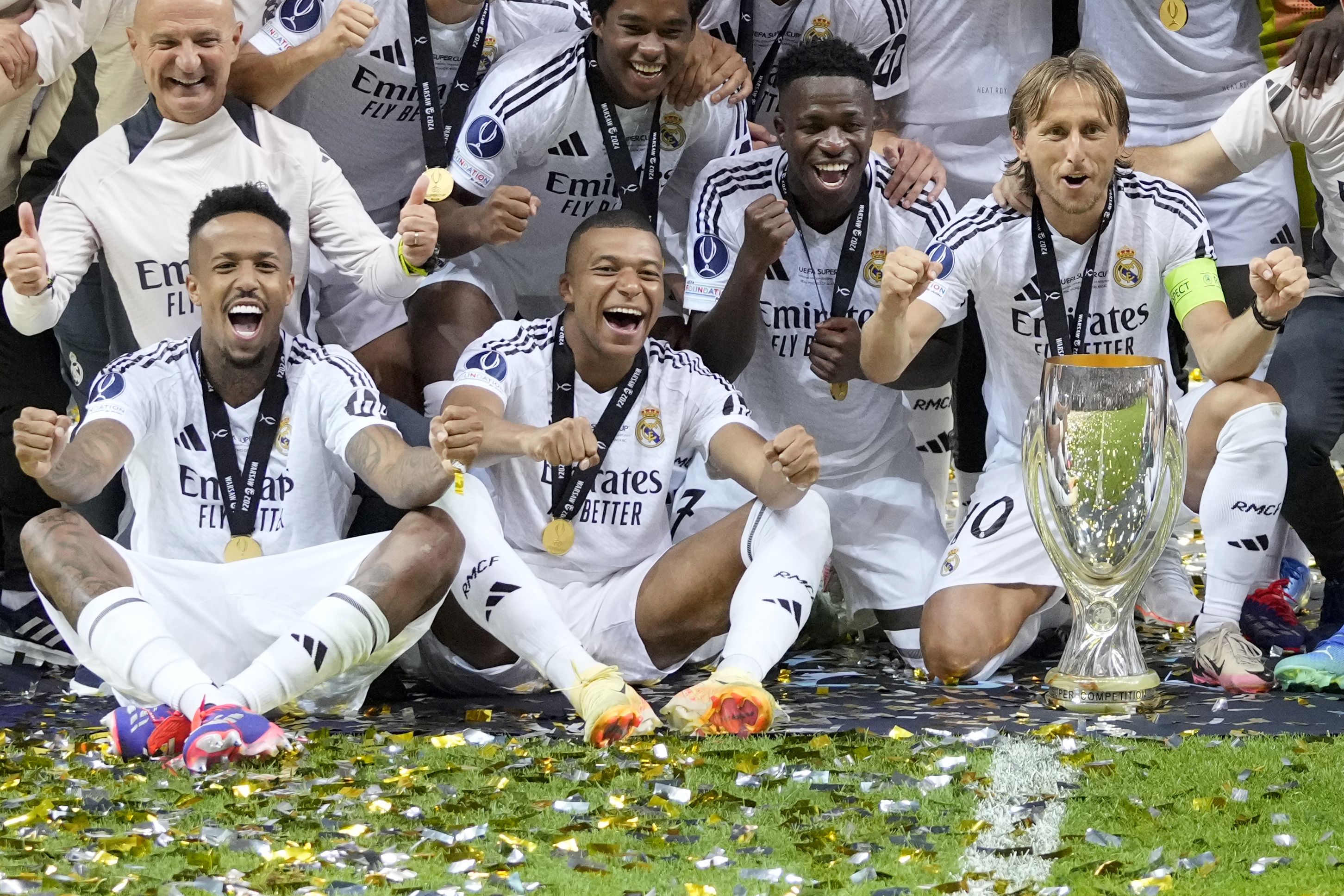 Real Madrid's Eder Militao, Kylian Mbappe, Vinicius Junior, and Luka Modric, from left, pose with the trophy after winning the UEFA Super Cup Final soccer match between Real Madrid and Atalanta at the Narodowy stadium in Warsaw, Poland, Wednesday, Aug. 14, 2024. Real Madrid won 2-0. 