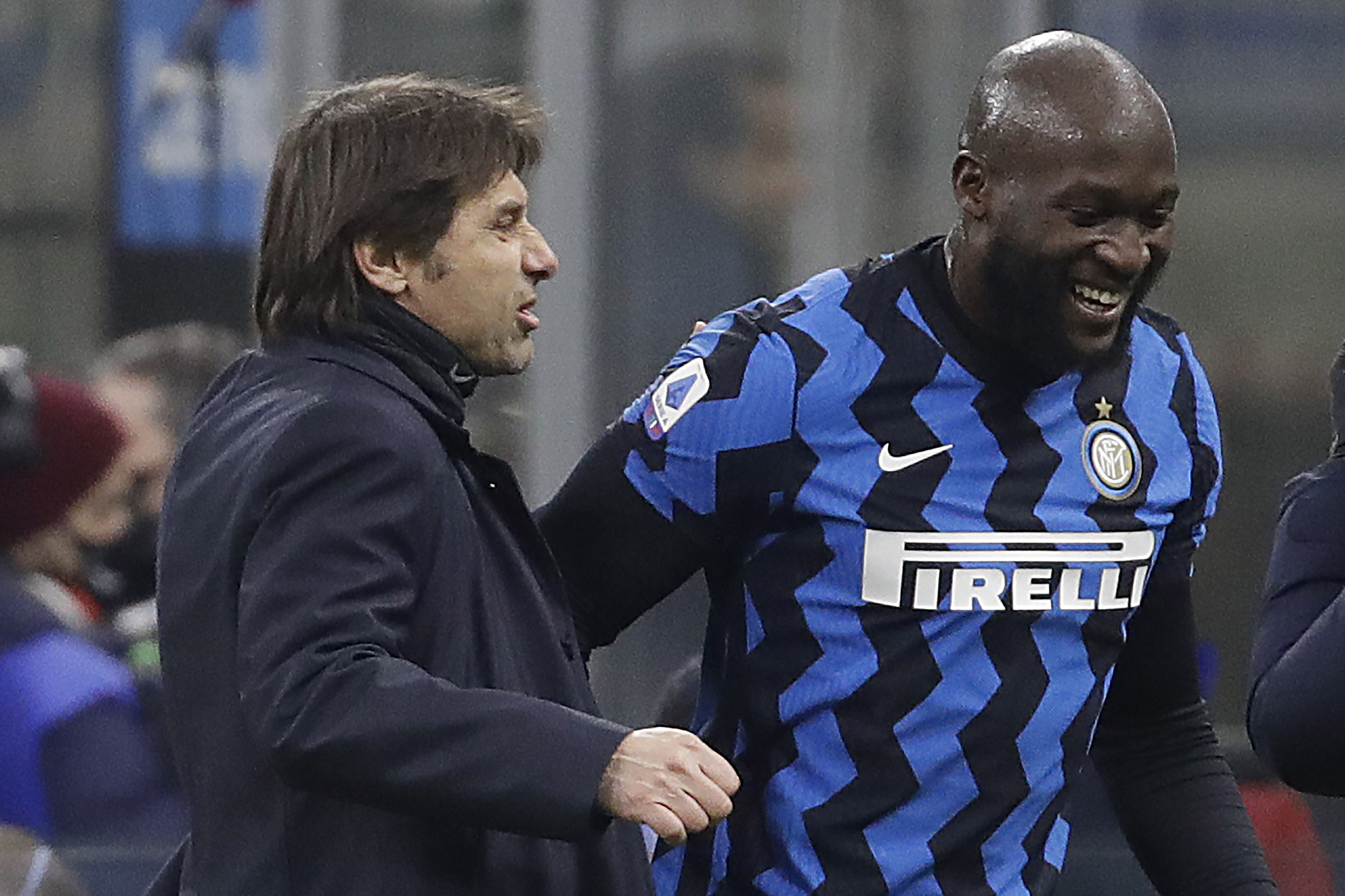 FILE - Inter Milan's head coach Antonio Conte congratulates his player Romelu Lukaku who scores the two goals during a Serie A soccer match between Inter Milan and Lazio at the San Siro stadium in Milan, Italy, Sunday, Feb. 14, 2021. 