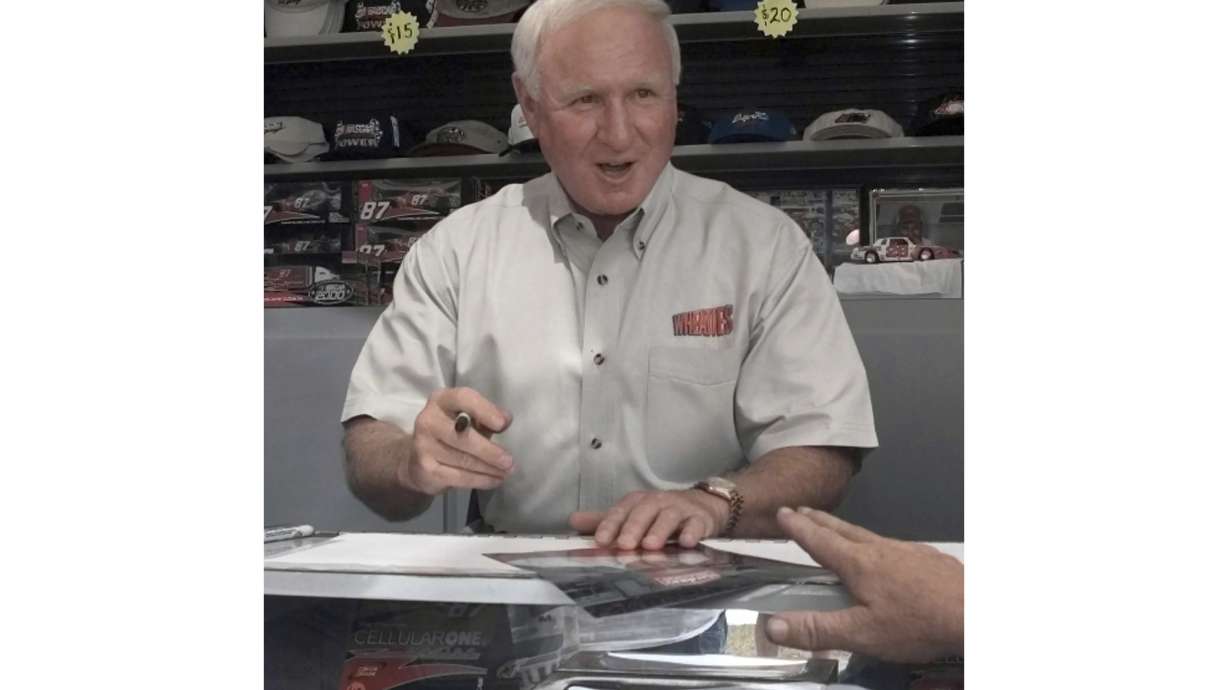 FILE - Cale Yarborough signs autographs for fans at Darlington Raceway Saturday, Sept. 2, 2000, in Darlington, S.C.