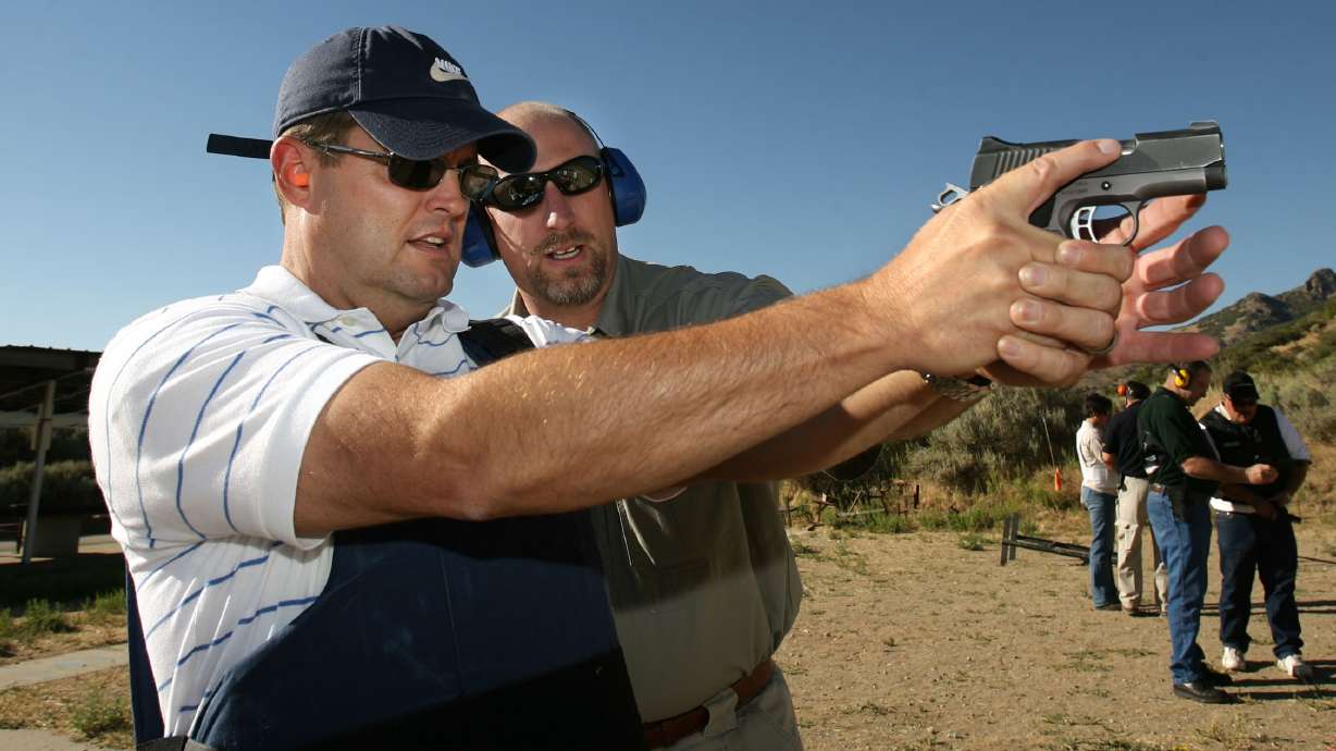 Rick Dutson gets shooting instructions from Farmington Police Lt. Shane Whitaker at a Davis County shooting range Aug 28, 2008. A shooting association is parting ways with Davis County after conflicts called the range's management structure into question.