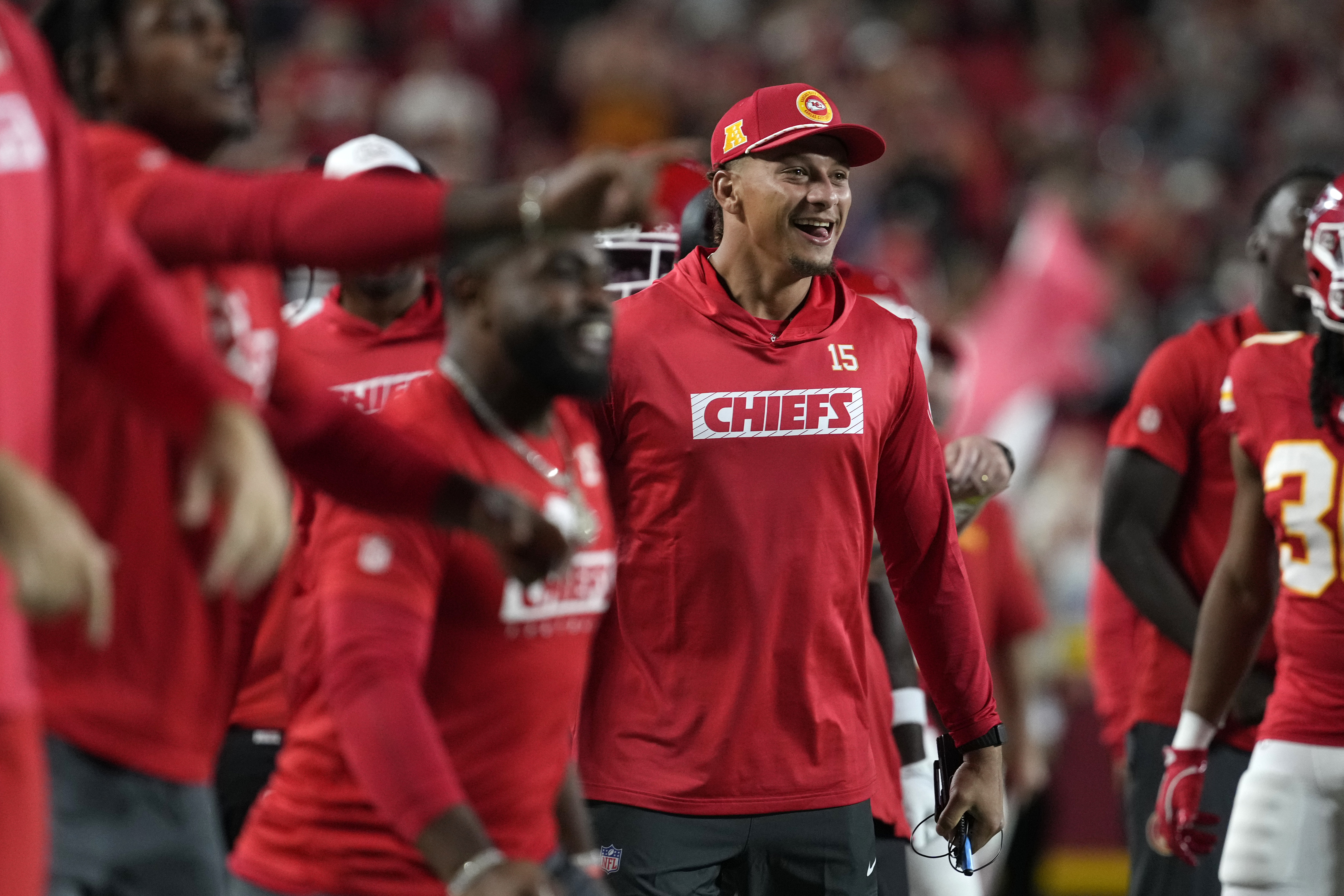 Kansas City Chiefs quarterback Patrick Mahomes celebrates on the sidelines during the first half of an NFL preseason football game against the Chicago Bears Thursday, Aug. 22, 2024, in Kansas City, Mo.