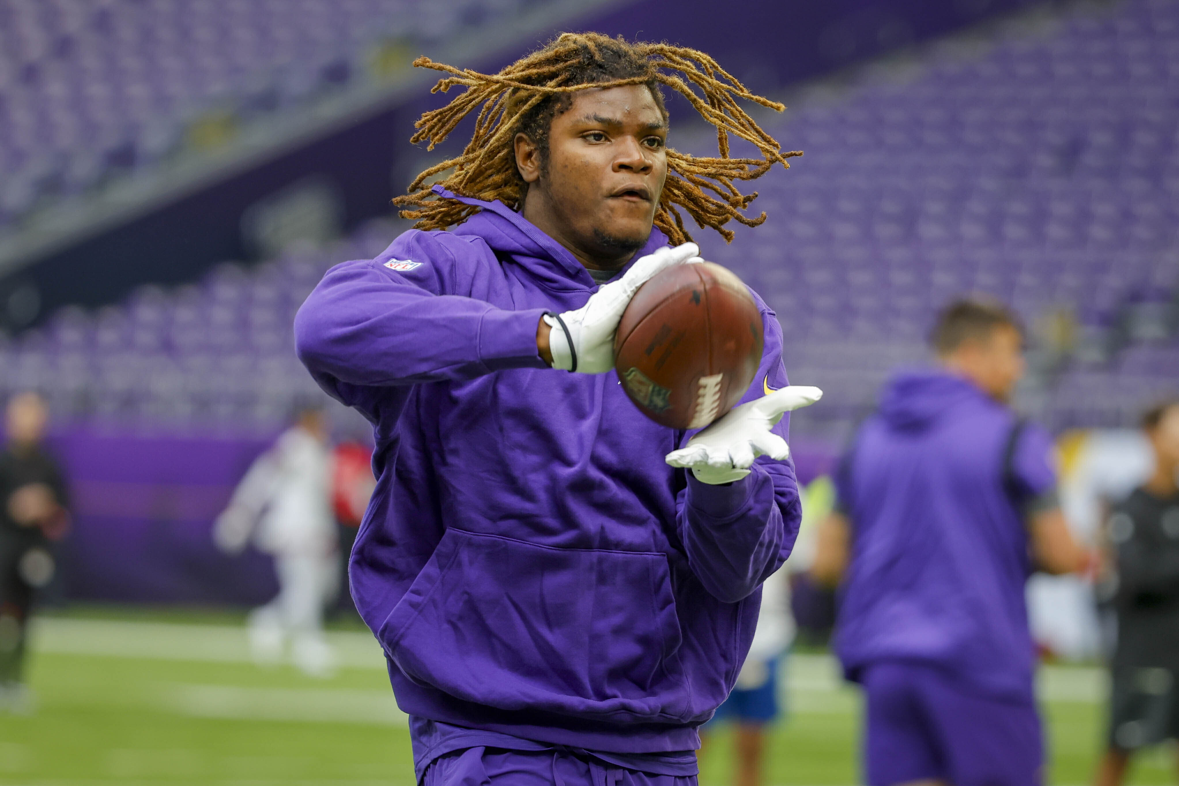 FILE - Minnesota Vikings safety Lewis Cine warms up prior to an NFL preseason football game against the Arizona Cardinals, Aug. 26, 2023, in Minneapolis.