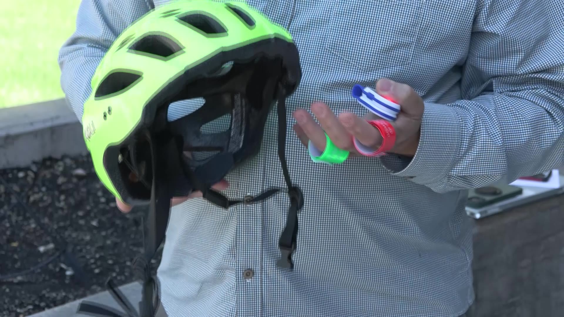 Jason Mettmann shows different safety equipment that e-bike riders should use on the road, Thursday.