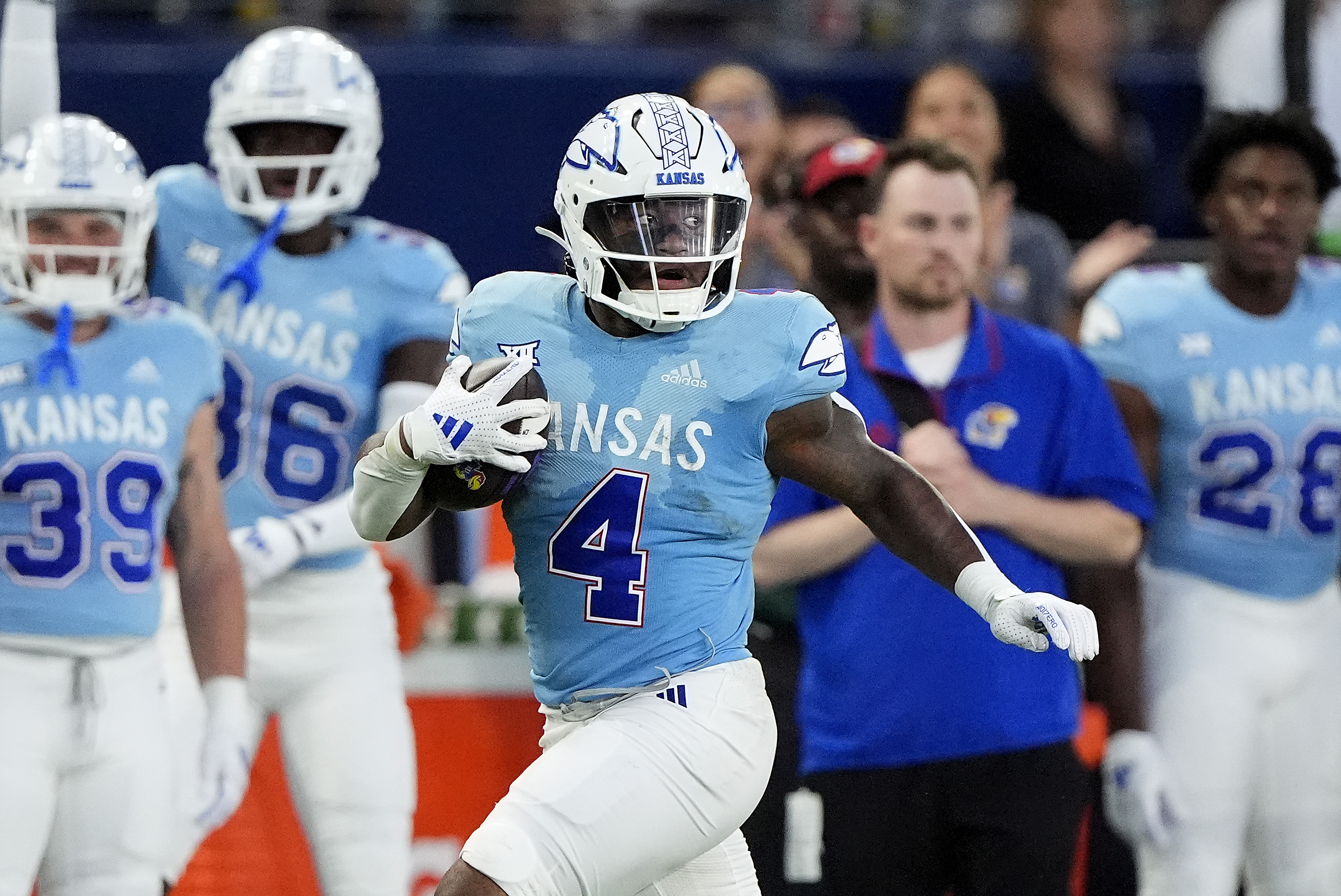 Kansas running back Devin Neal (4) runs for a first down during the first half of an NCAA college football game against Lindenwood Thursday, Aug. 29, 2024, at Children's Mercy Park in Kansas City, Kan. 
