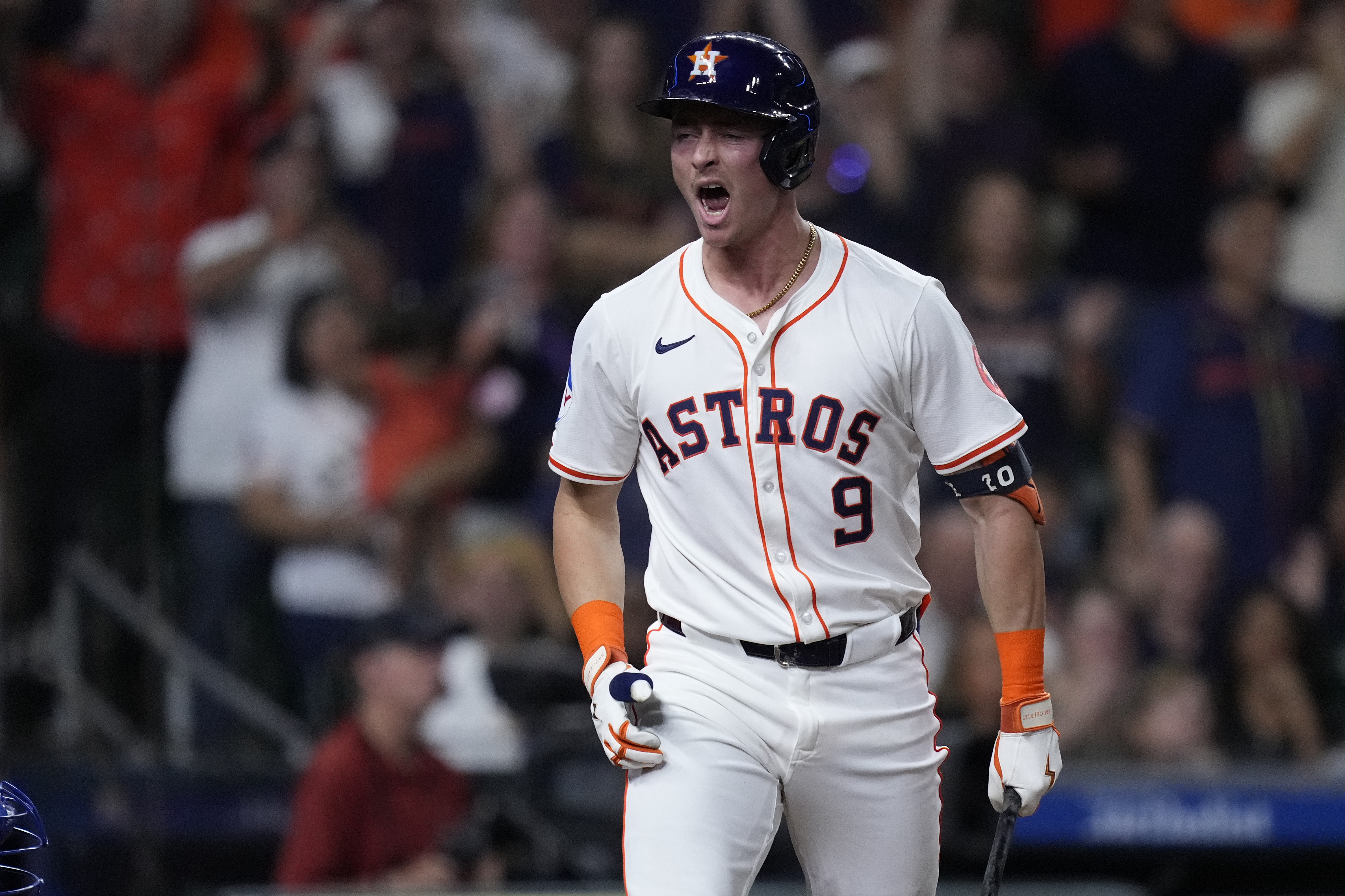 Houston Astros' Zach Dezenzo celebrates after drawing a bases-loaded walk during the eighth inning of a baseball game against the Kansas City Royals, Thursday, Aug. 29, 2024, in Houston. 