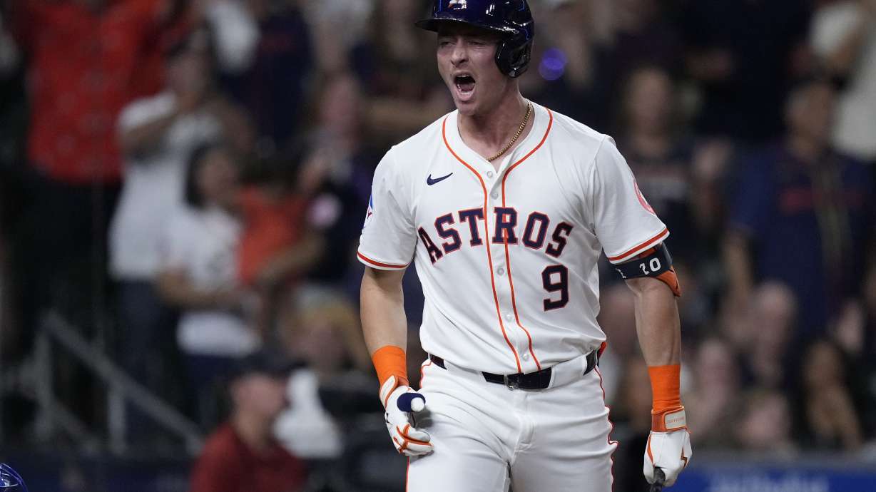 Houston Astros' Zach Dezenzo celebrates after drawing a bases-loaded walk during the eighth inning of a baseball game against the Kansas City Royals, Thursday, Aug. 29, 2024, in Houston.