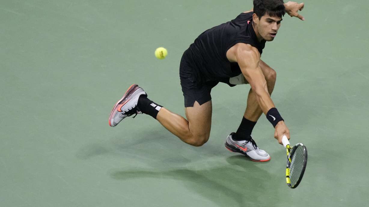 Carlos Alcaraz, of Spain returns a shot to Botic van De Zandschulp, of the Netherlands, during the second round of the U.S. Open tennis championships, Thursday, Aug. 29, 2024, in New York.