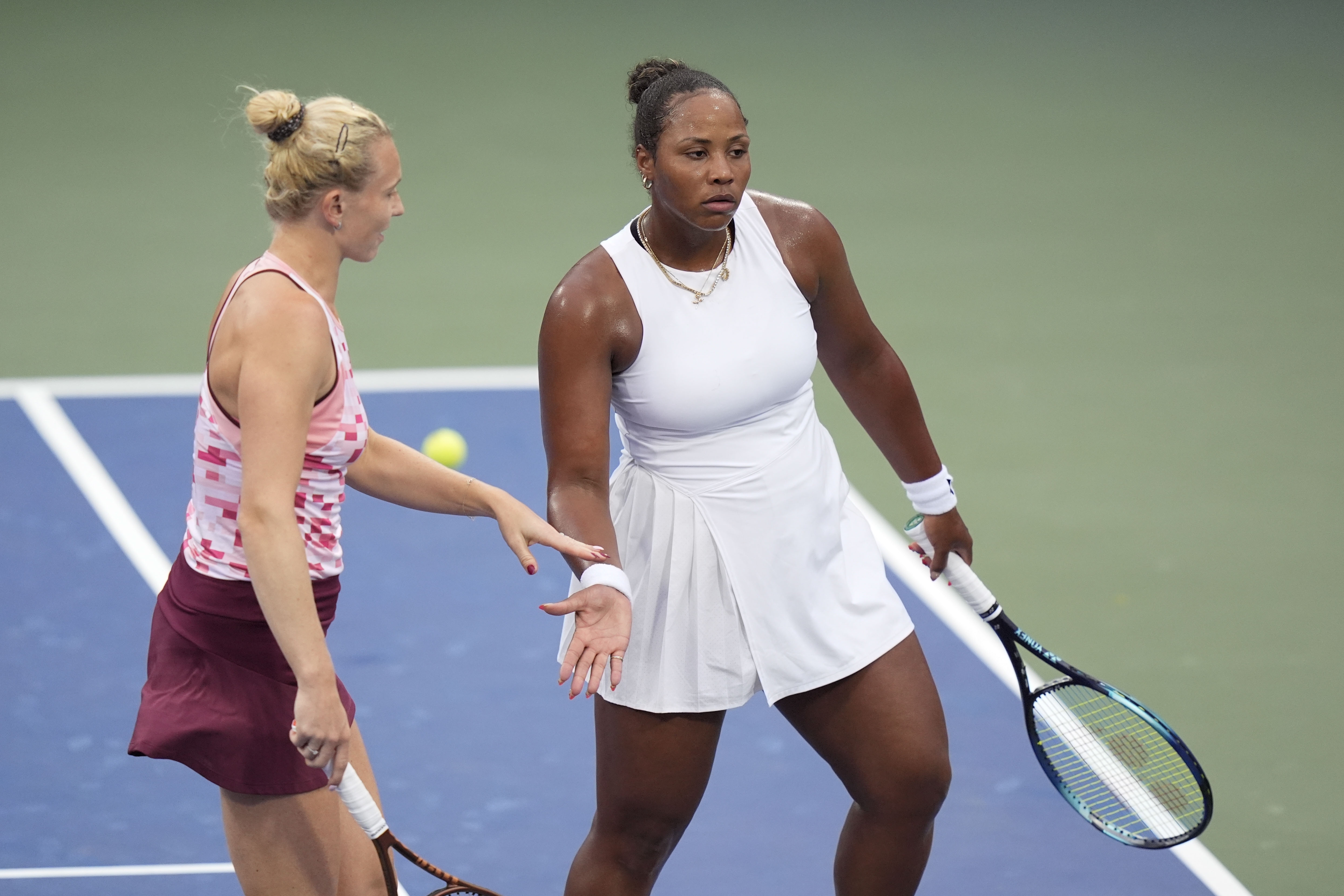 Katerina Siniakova, of the Czech Republic, and Taylor Townsend, of the United States, react during a second round match of the U.S. Open tennis championships, Thursday, Aug. 29, 2024, in New York. 