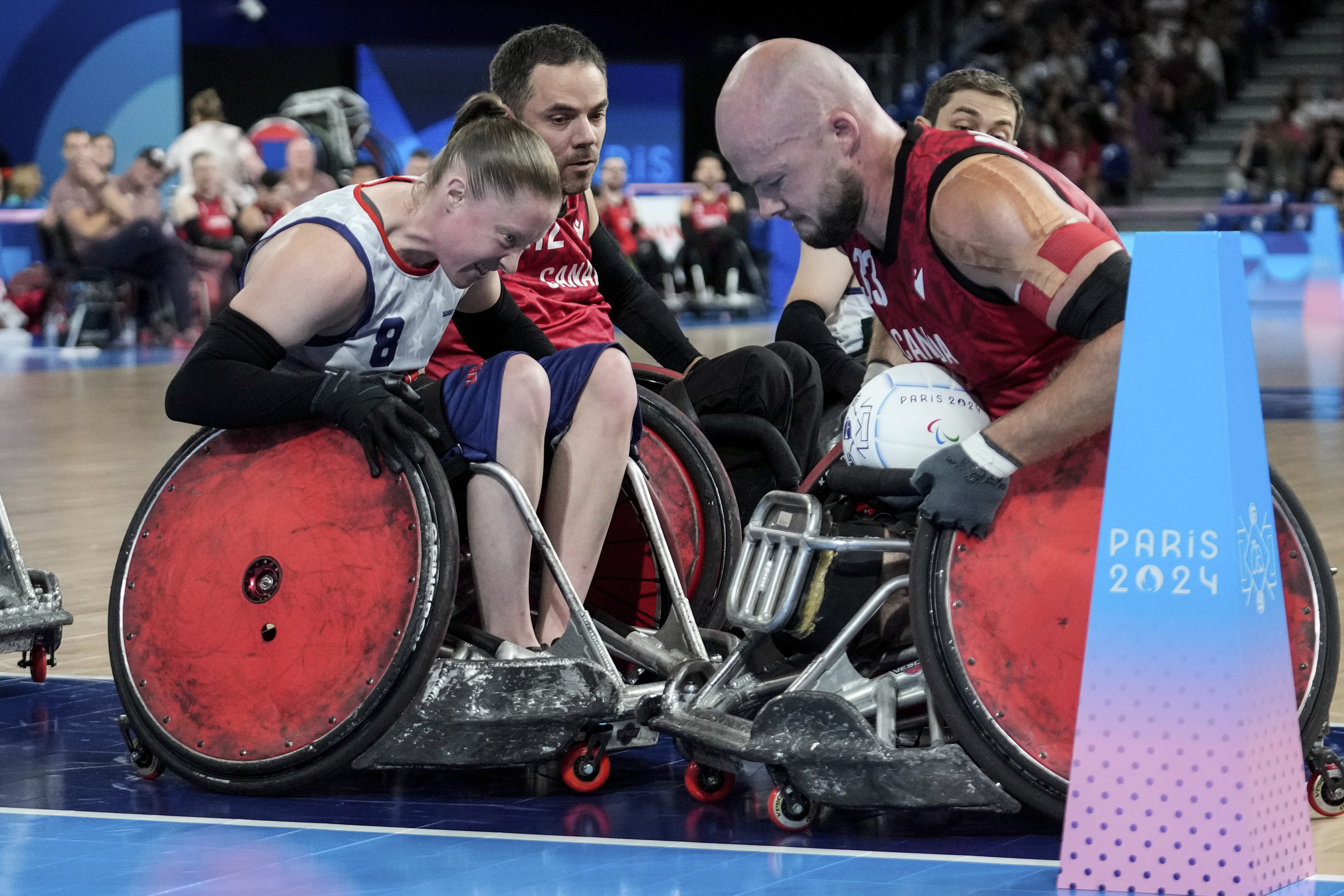 Sarah Adam of the United States, left, blocks Zachary Madel of Canada during the 2024 Paralympics Wheelchair Rugby match United States against Canada at the Champs Mars Arena Thursday, Aug. 29, 2024, in Paris, France. 