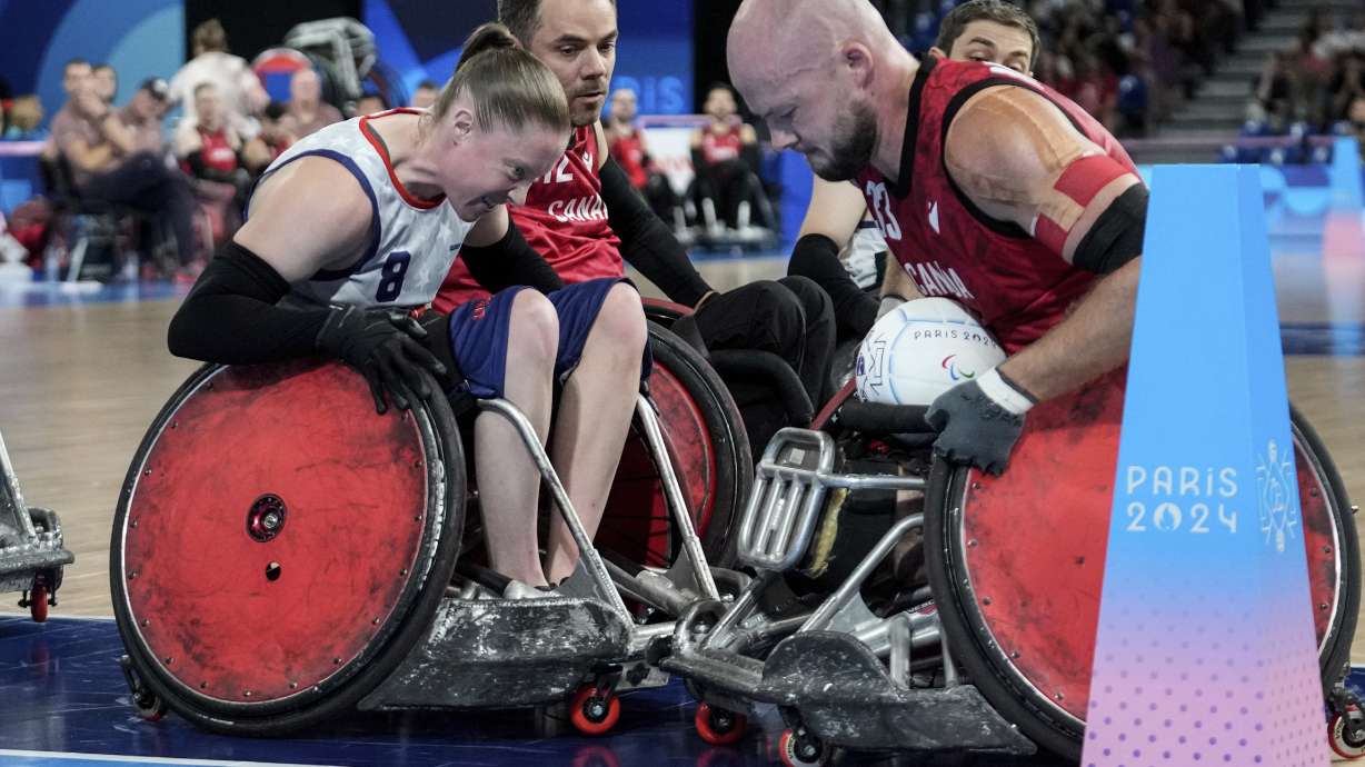 Sarah Adam of the United States, left, blocks Zachary Madel of Canada during the 2024 Paralympics Wheelchair Rugby match United States against Canada at the Champs Mars Arena Thursday, Aug. 29, 2024, in Paris, France.