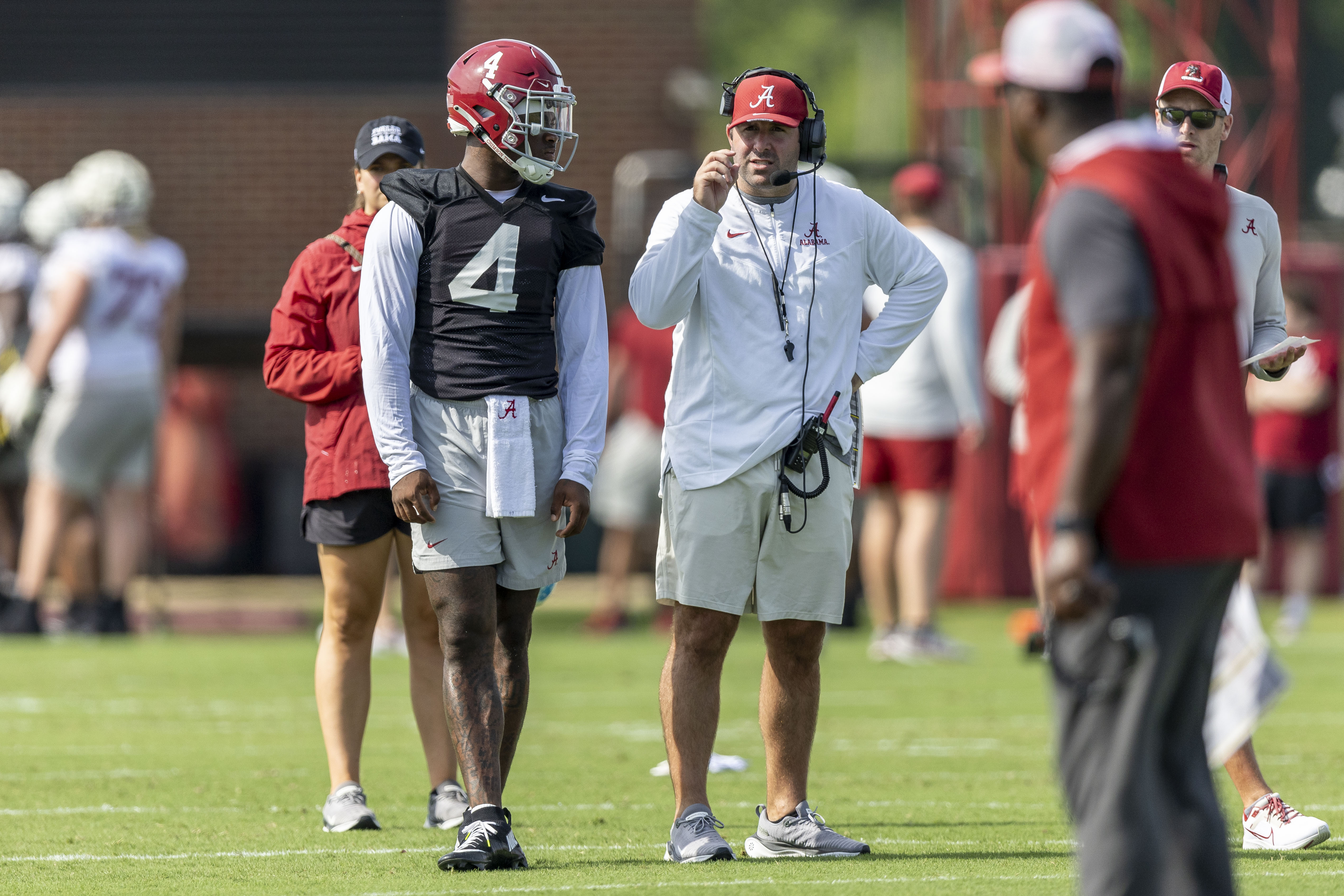 Alabama offensive coordinator Nick Sheridan coaches quarterback Jalen Milroe (4) during NCAA college football practice, Wednesday, July 31, 2024, at the Thomas-Drew Practice Fields in Tuscaloosa, Ala. 
