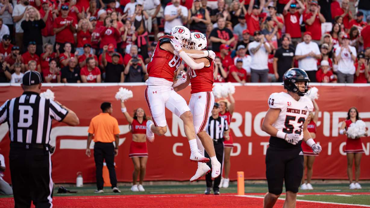 Utah tight ends Brant Kuithe (80) and Caleb Lohner (84) celebrate a touchdown against Southern Utah on Aug. 29, 2024 in Salt Lake City.