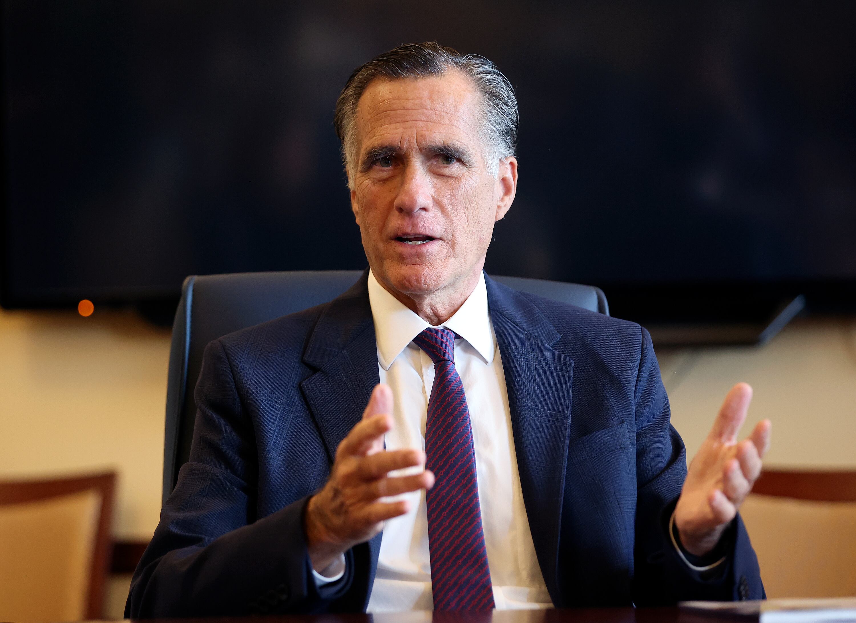 Sen. Mitt Romney, R-Utah, meets with Senate Democrats during their caucus meeting at the Capitol in Salt Lake City on Feb. 15. Vice President Kamala Harris announced she'd appoint a Republican to her Cabinet if she is elected president.