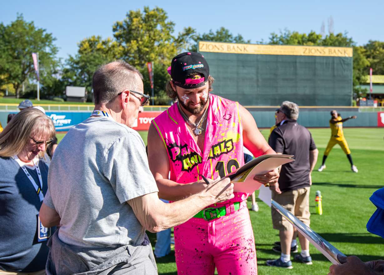 Savannah Party Animals pitcher and University of Utah alumnus Bret Helton signs autographs for fans before the team plays the Savannah Bananas at Smith's Ballpark in Salt Lake City on Friday.