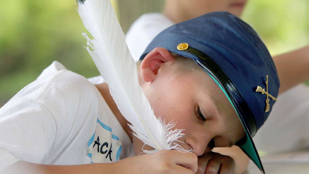 Kids write letters home using quill pens while attending the Camp Floyd Stagecoach Inn History Camp in Fairfield, June 9, 2006. There's lots going on in Utah to enjoy time with family and friends.