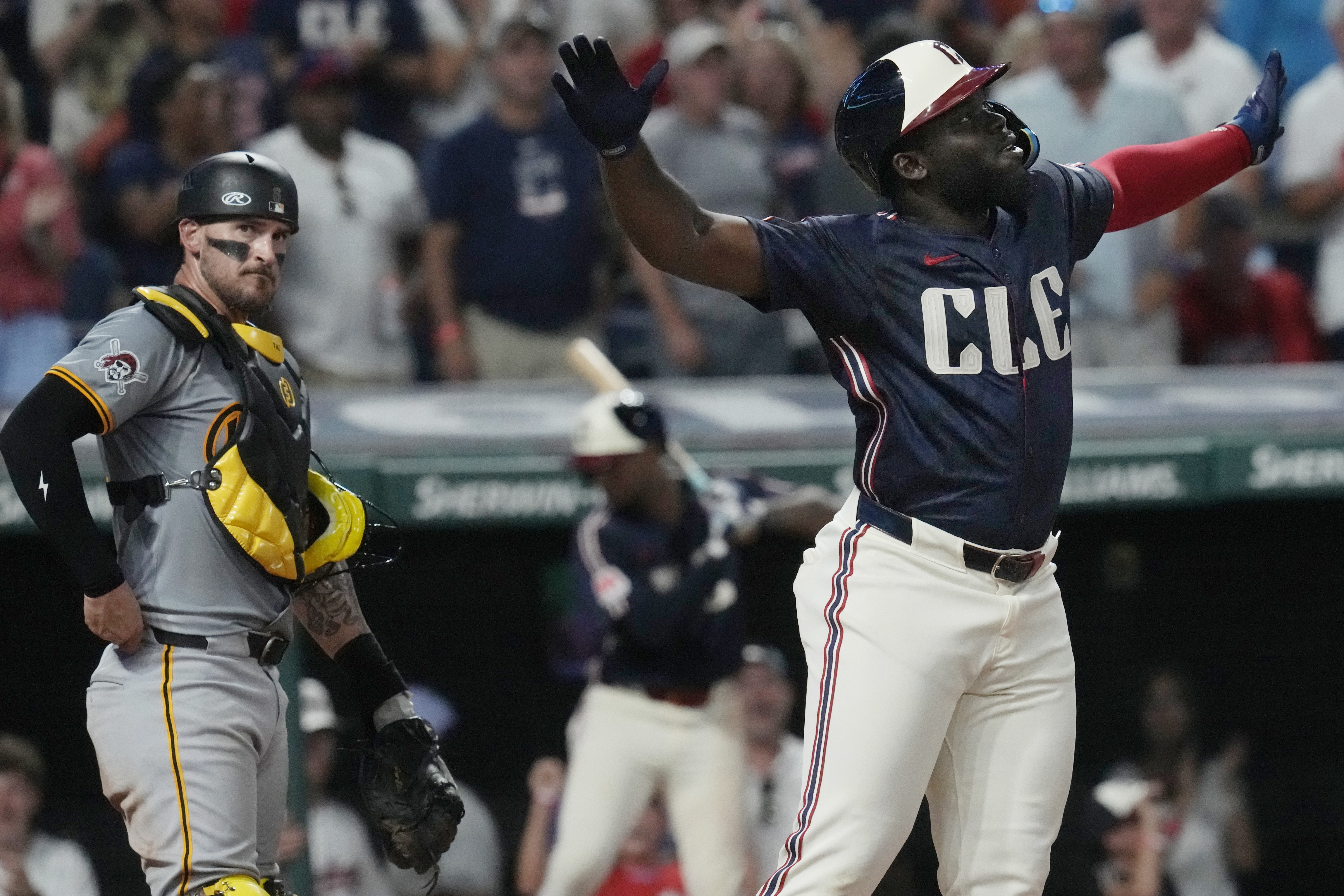 Cleveland Guardians' Jhonkensy Noel, right, celebrates in front of Pittsburgh Pirates catcher Yasmani Grandal, left, after hitting a home run in the fifth inning of a baseball game, Friday, Aug. 30, 2024, in Cleveland. 