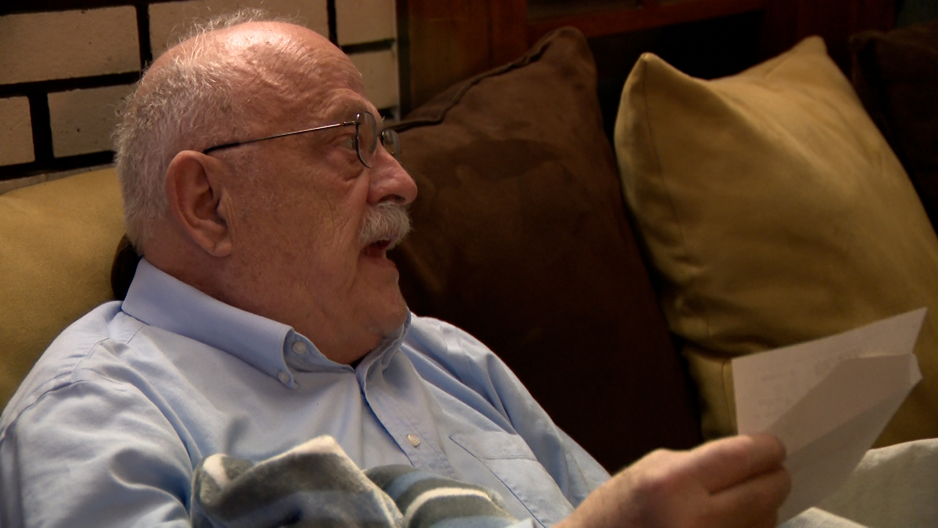 Robert Kirk reacts to the Wilson family giving him a check.