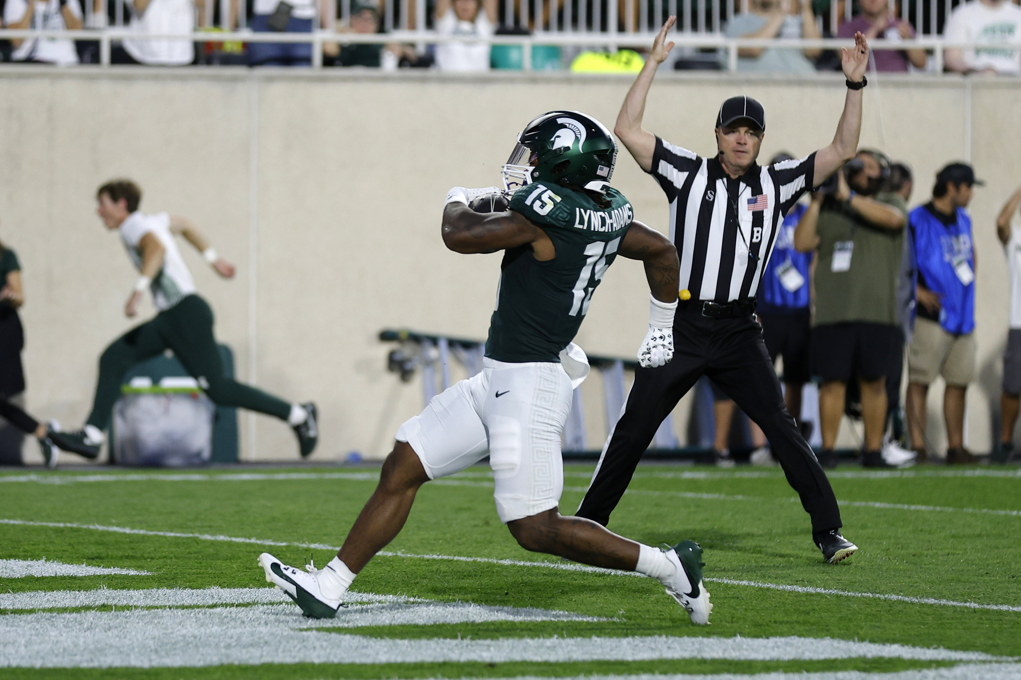 Michigan State running back Kay'Ron Lynch-Adams (15) scores on a rushing touchdown during the second quarter of an NCAA college football game, Friday, Aug. 30, 2024, in East Lansing, Mich. 