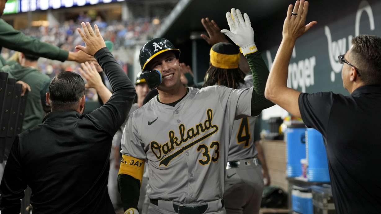 Oakland Athletics' JJ Bleday (33) celebrates his three-run home run against the Texas Rangers in the third inning of a baseball game, Friday, Aug. 30, 2024, in Arlington, Texas.