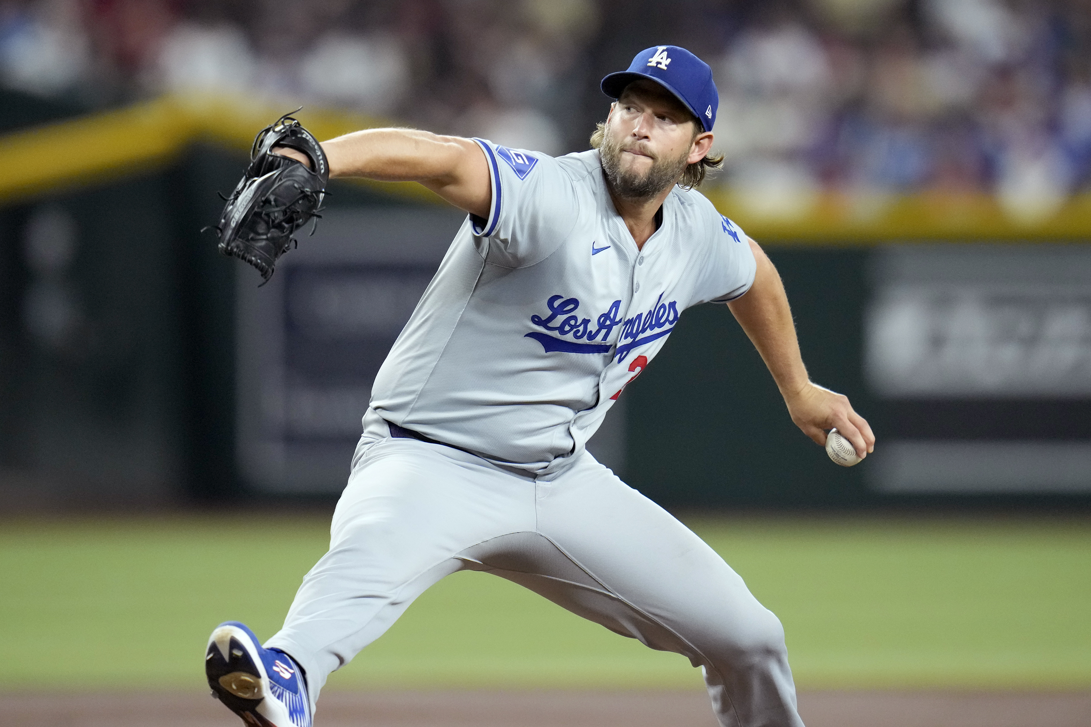 Los Angeles Dodgers pitcher Clayton Kershaw throws against the Arizona Diamondbacks during the first inning of a baseball game Friday, Aug. 30, 2024, in Phoenix. 