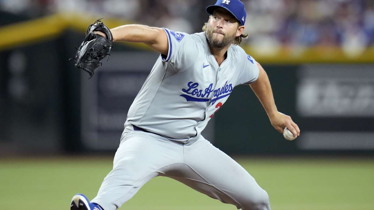 Los Angeles Dodgers pitcher Clayton Kershaw throws against the Arizona Diamondbacks during the first inning of a baseball game Friday, Aug. 30, 2024, in Phoenix.
