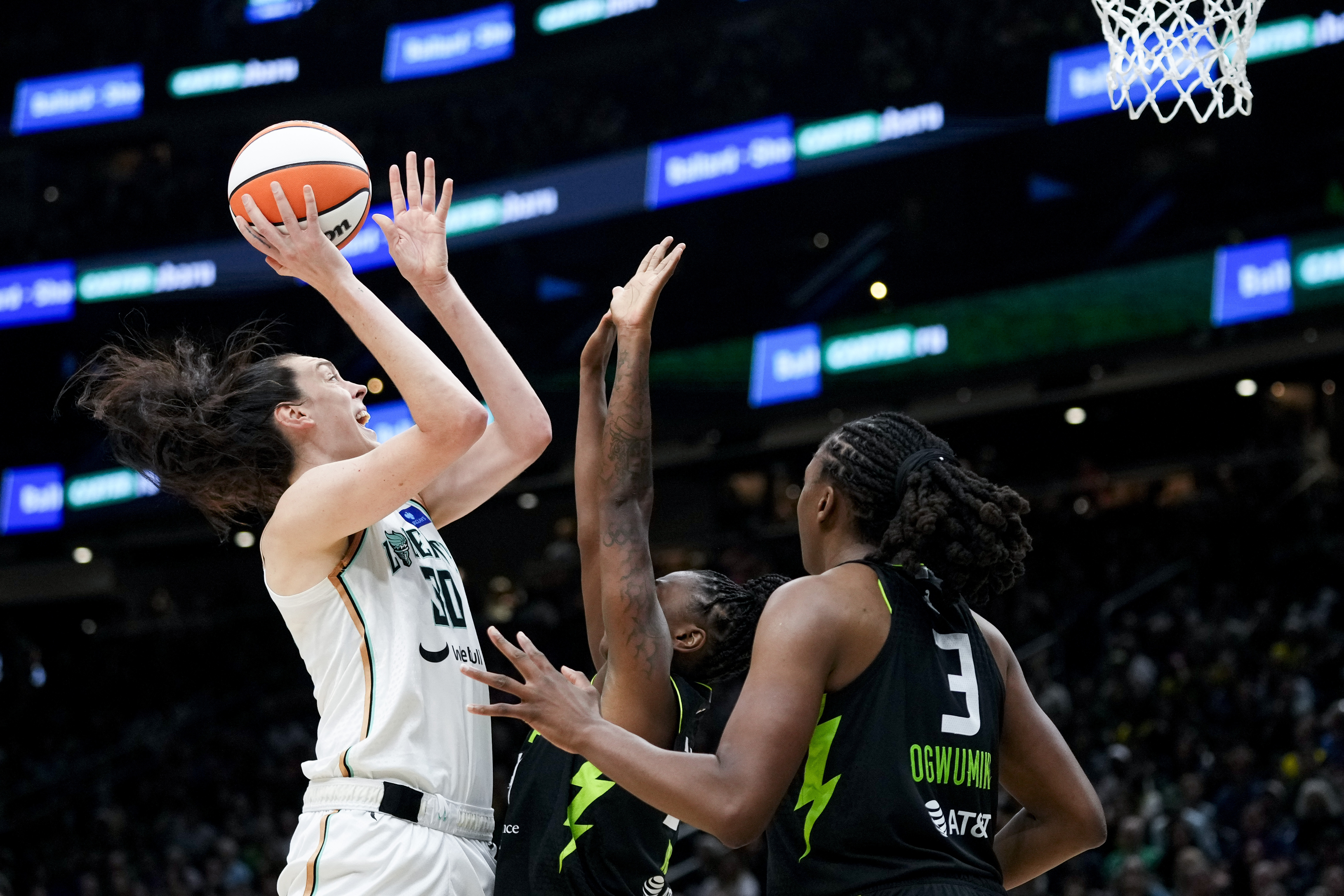 New York Liberty forward Breanna Stewart goes up to the basket against Seattle Storm guard Jewell Loyd, center, and forward Nneka Ogwumike (3) during the second half of a WNBA basketball game Friday, Aug. 30, 2024, in Seattle. The Liberty won 98-85.