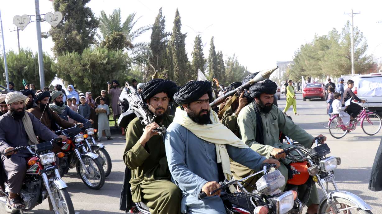Taliban fighters celebrate the third anniversary of the withdrawal of U.S.-led troops from Afghanistan, in Lashkar Gah, Helmand province, southwestern Afghanistan, Aug. 14.